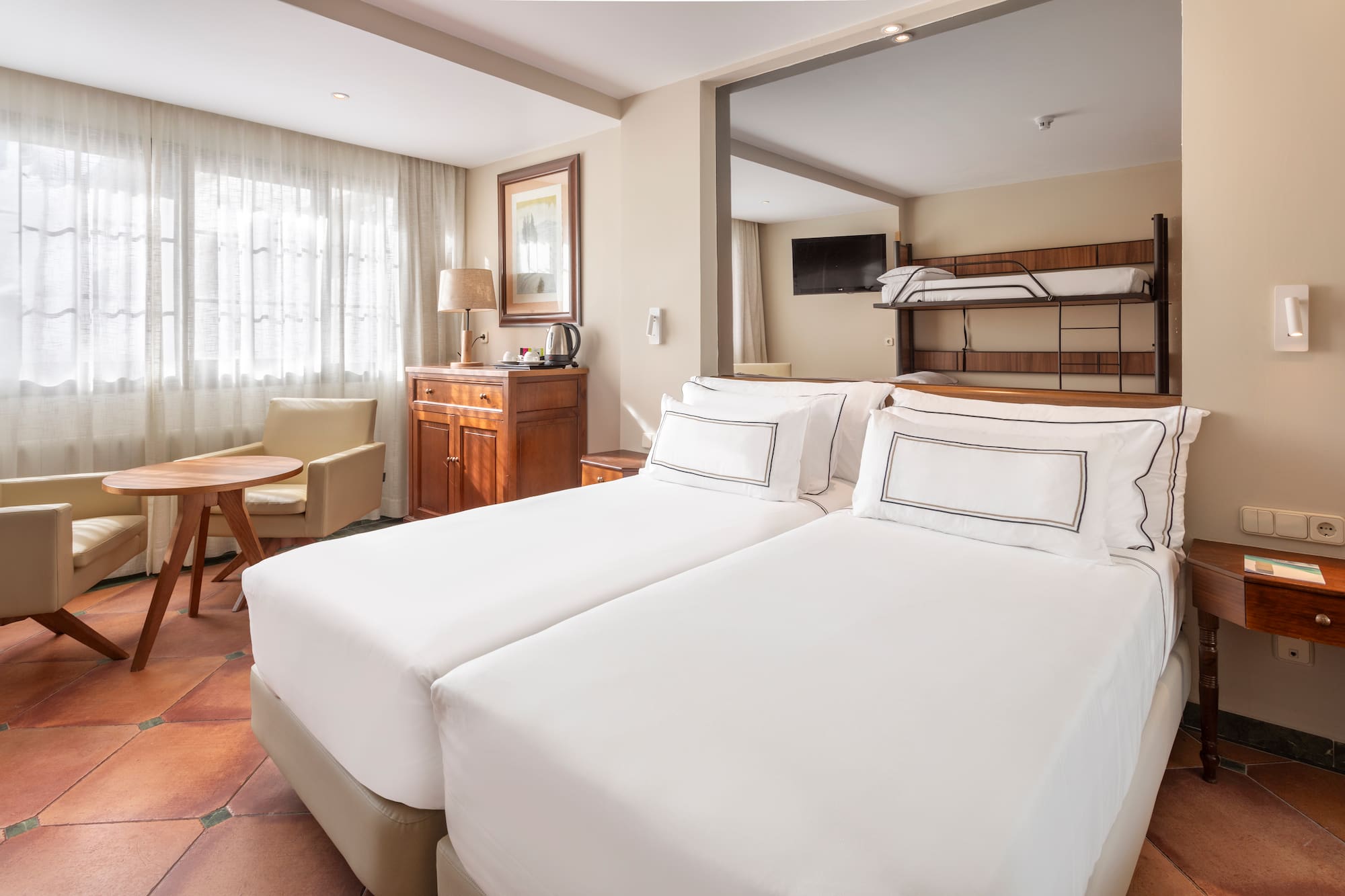 a room with two beds and a bunk bed