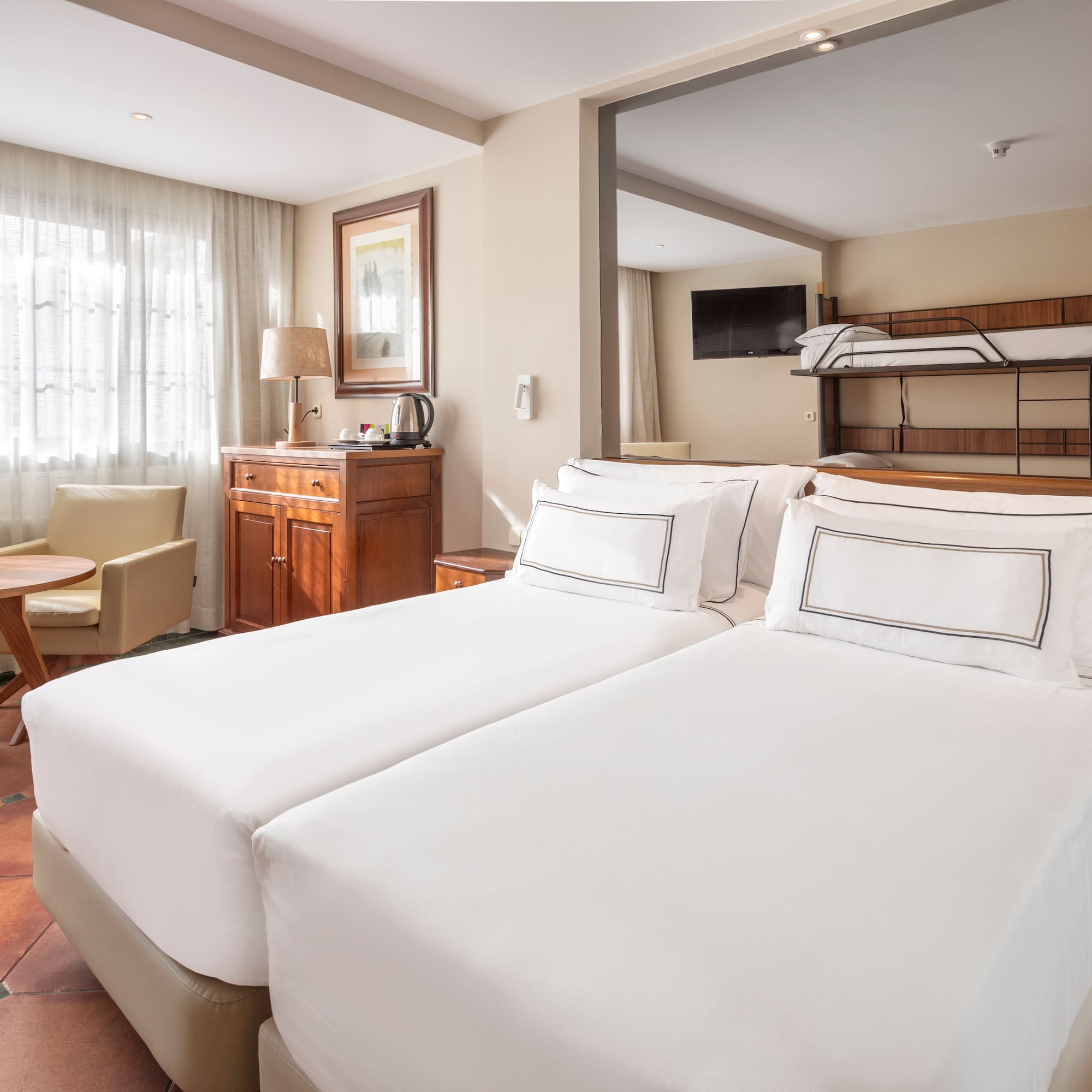 a room with two beds and a bunk bed