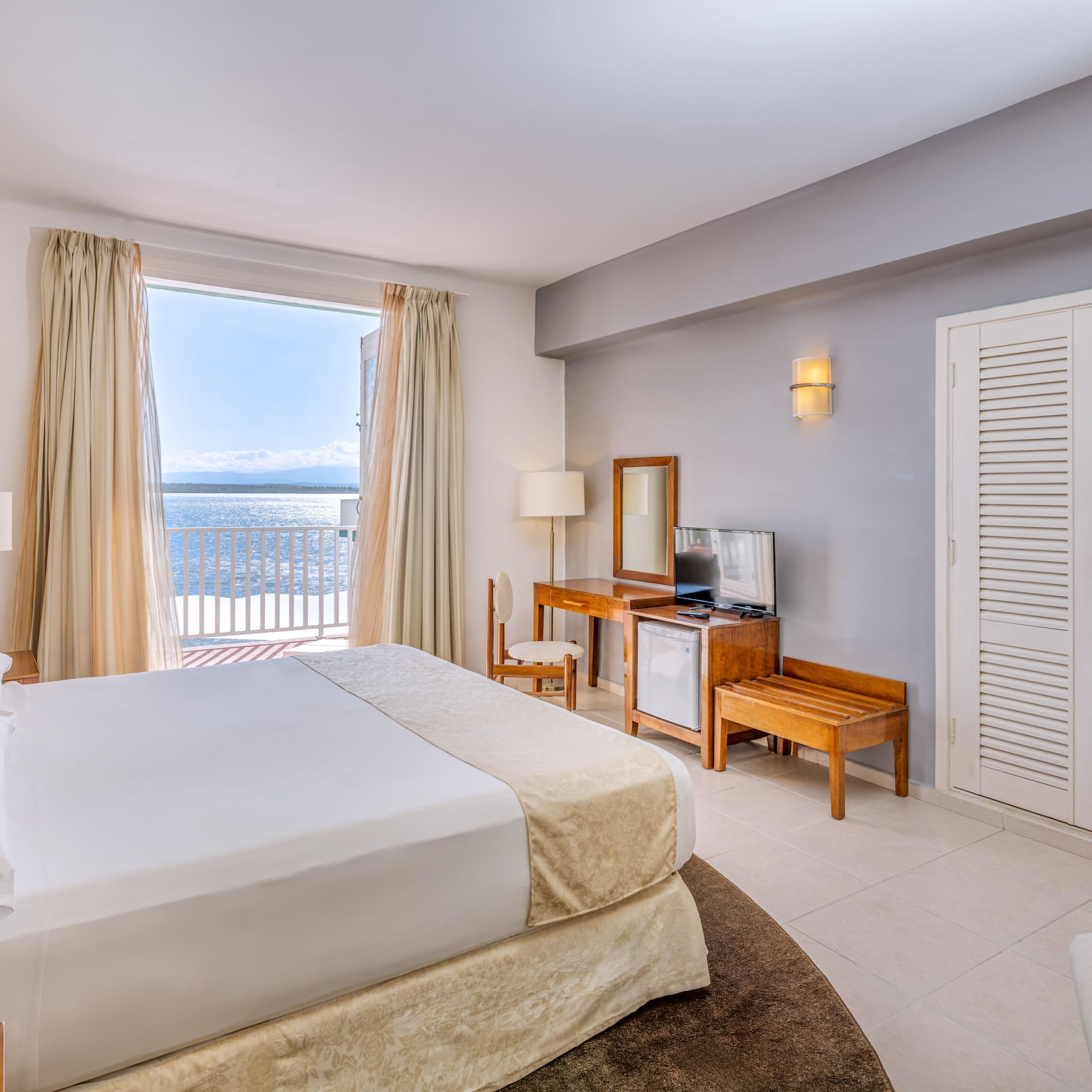 a bedroom with a large bed and a television