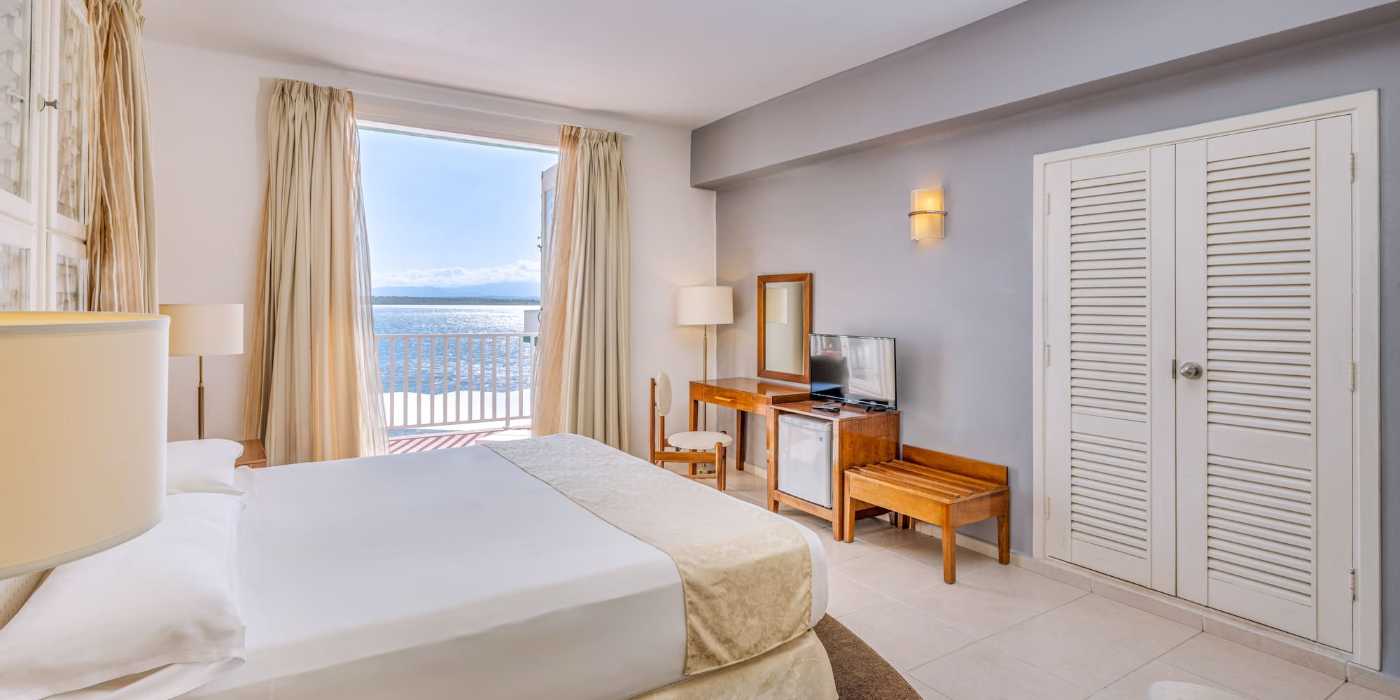 a bedroom with a large bed and a television