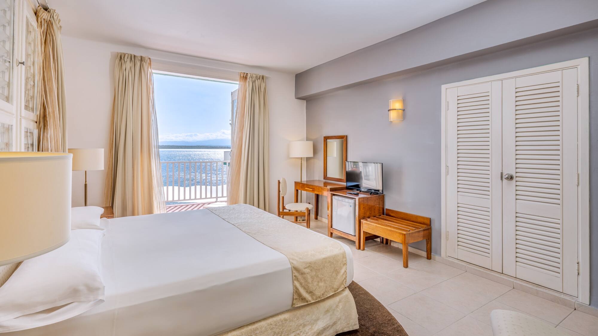 a bedroom with a large bed and a television