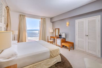 a bedroom with a large bed and a television