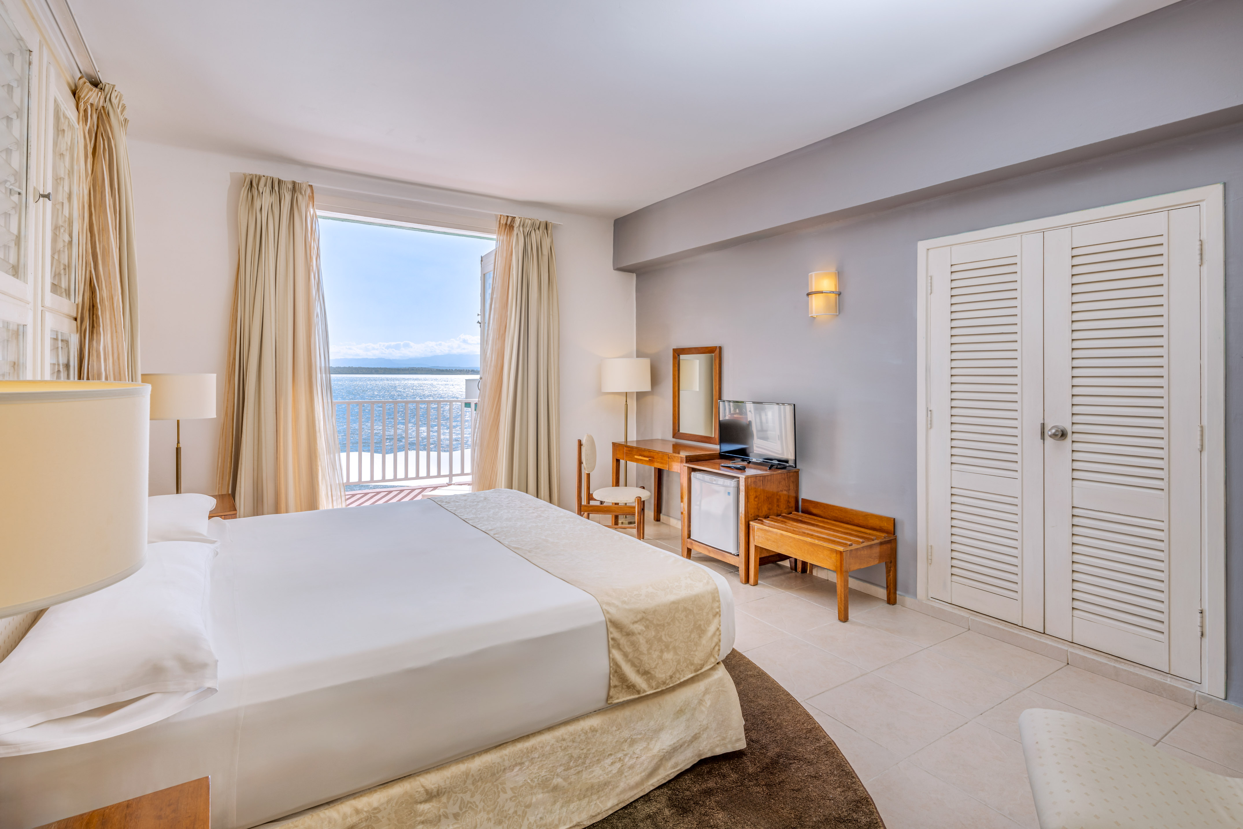 a bedroom with a large bed and a television