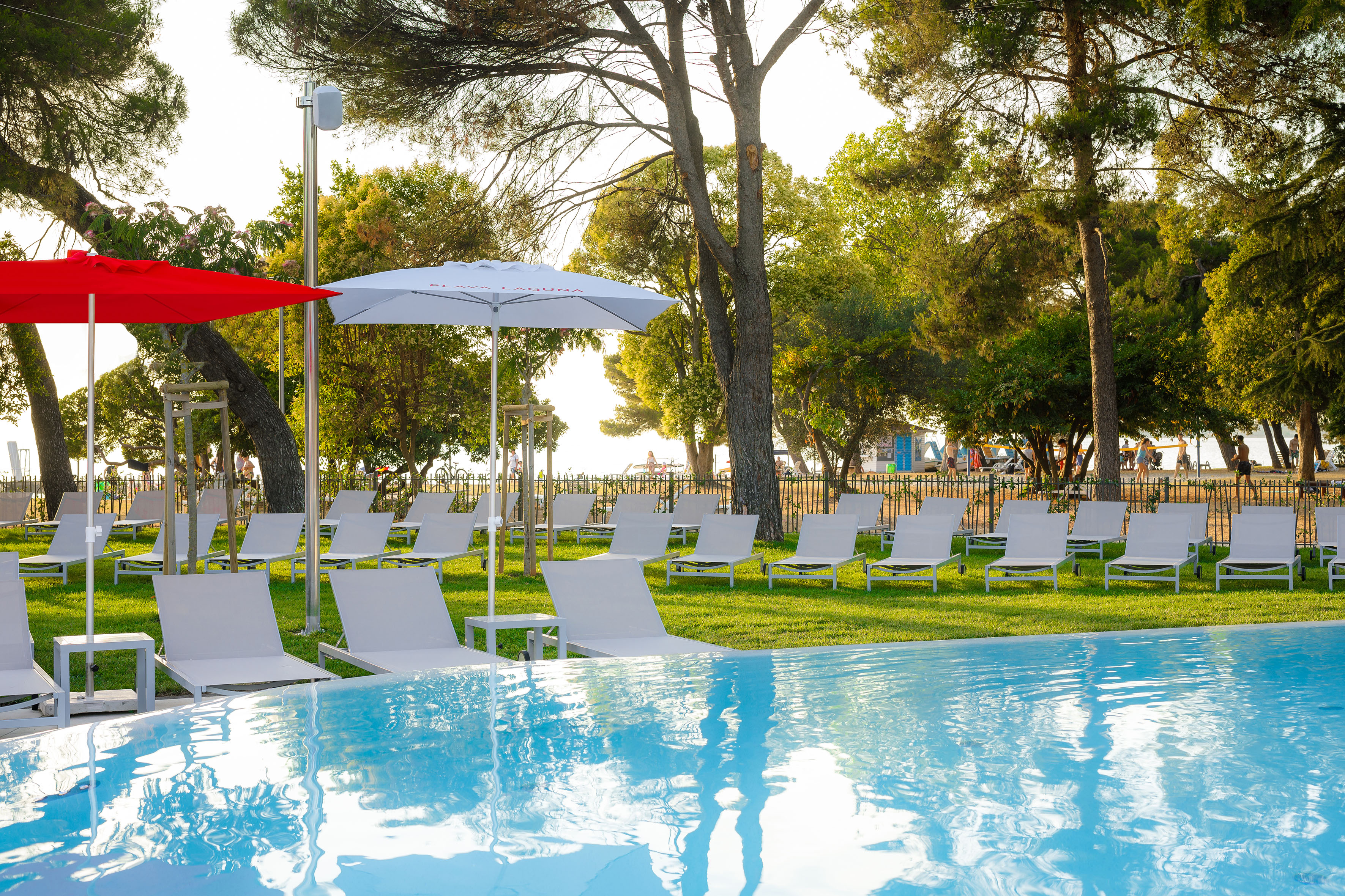 a pool with chairs and umbrellas in the middle
