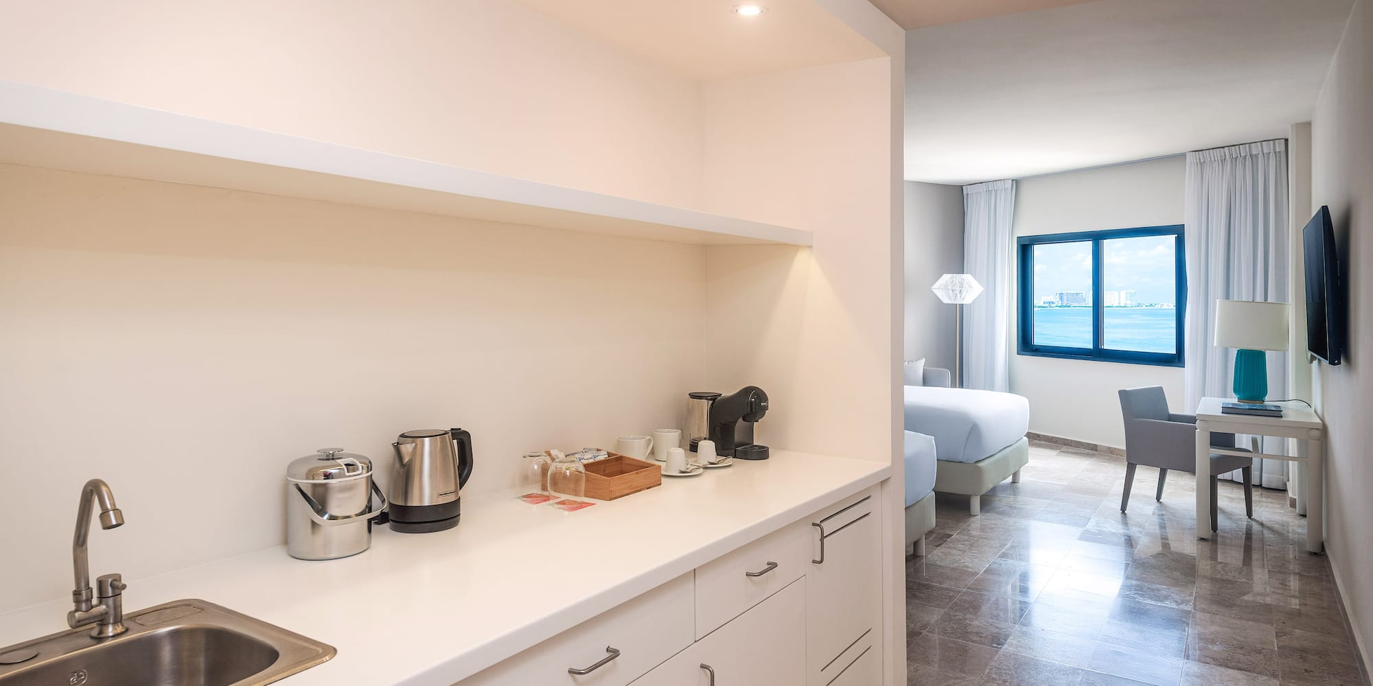 a kitchen with white cabinets and a sink