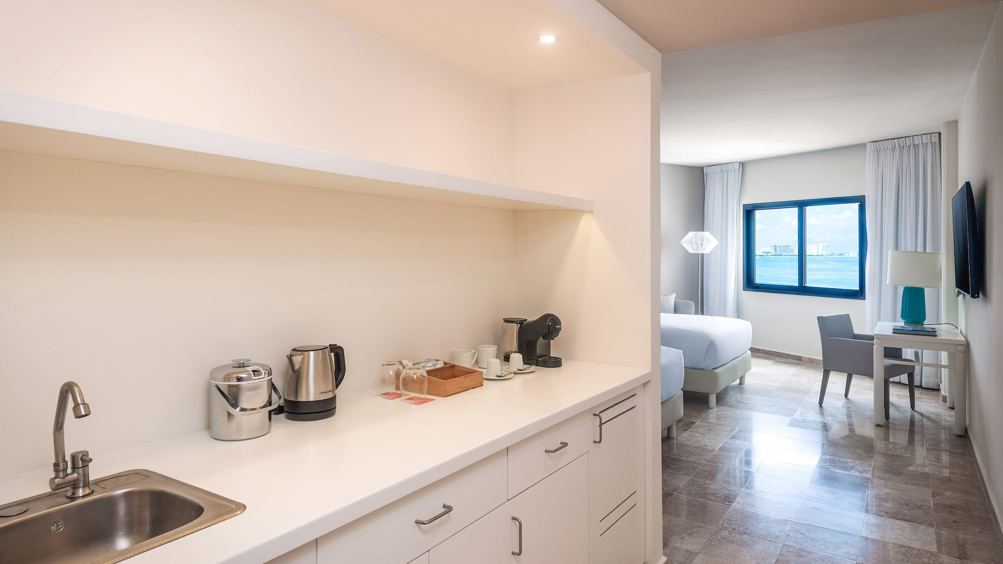 a kitchen with white cabinets and a sink