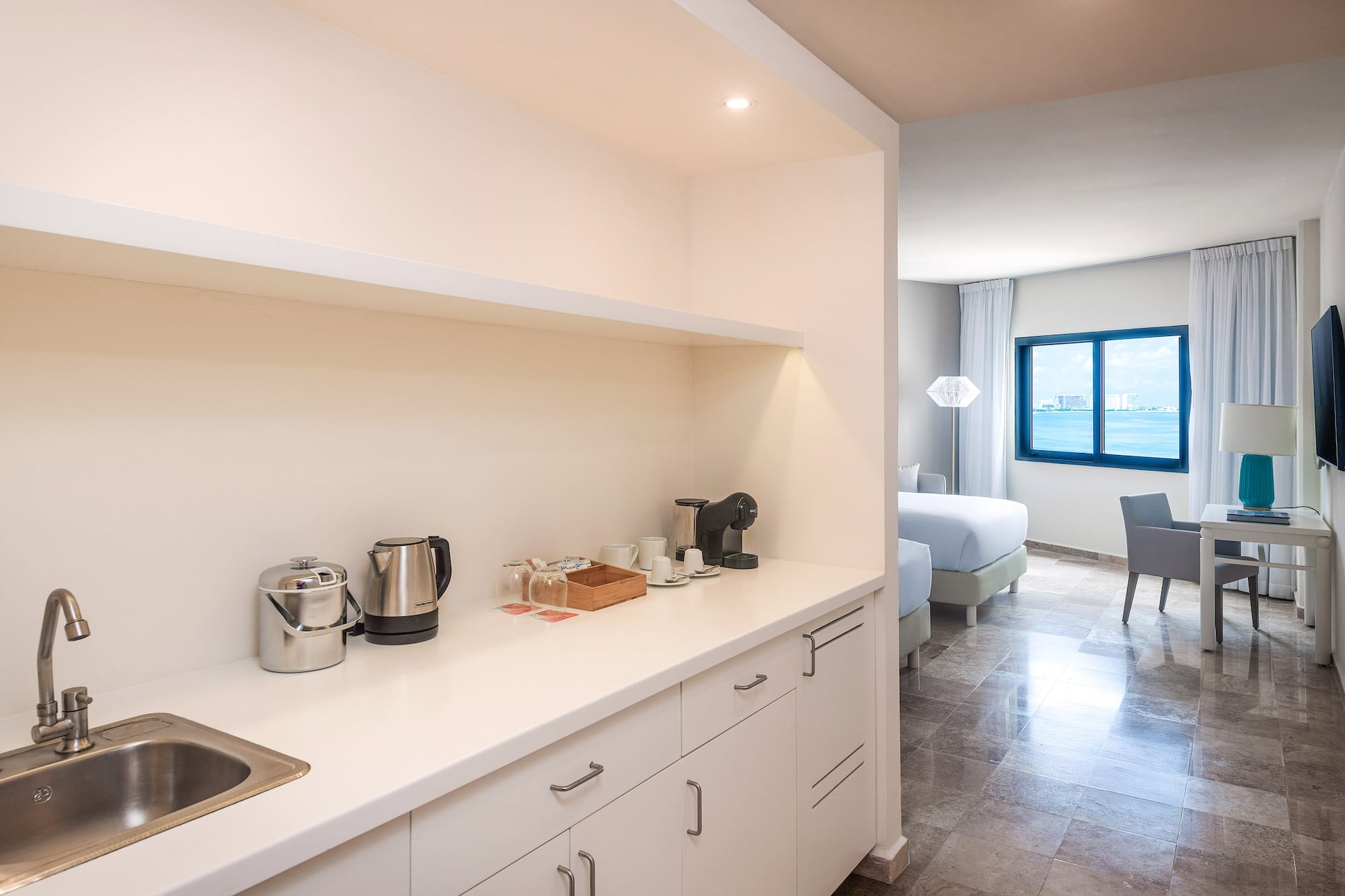 a kitchen with white cabinets and a sink