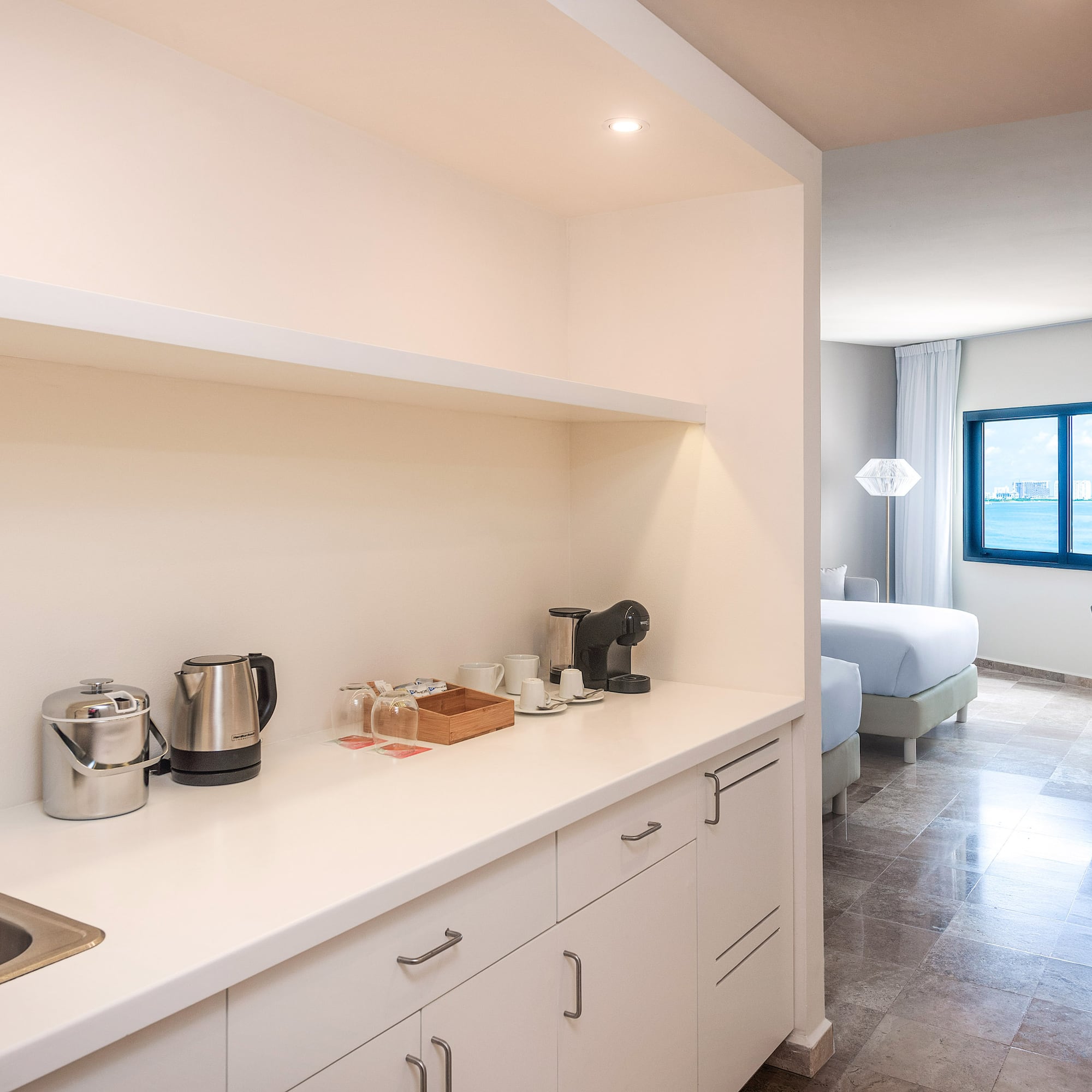 a kitchen with white cabinets and a sink