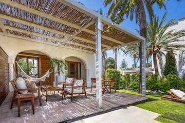 a patio with chairs and a hammock