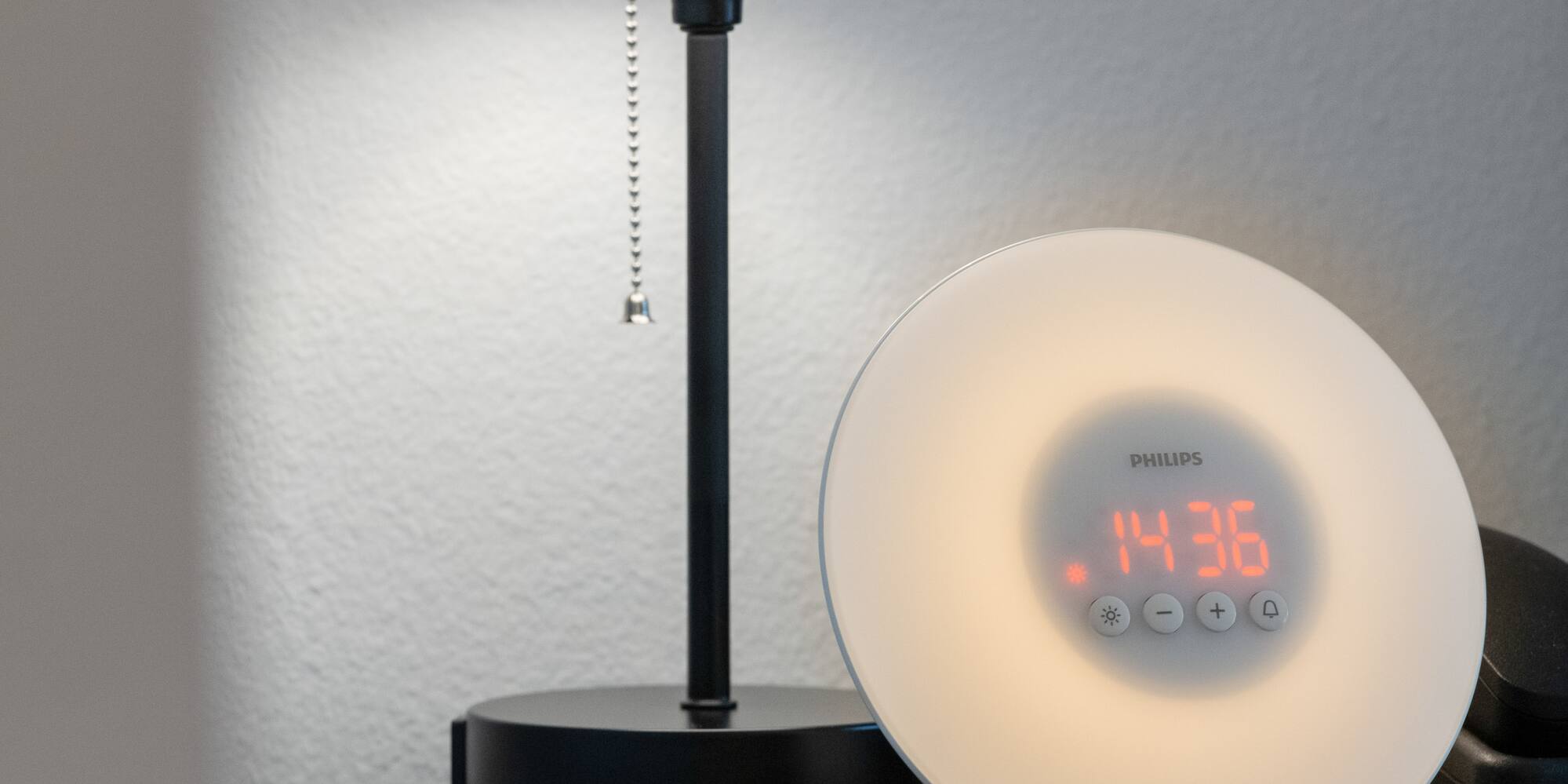 a clock on a table next to a lamp