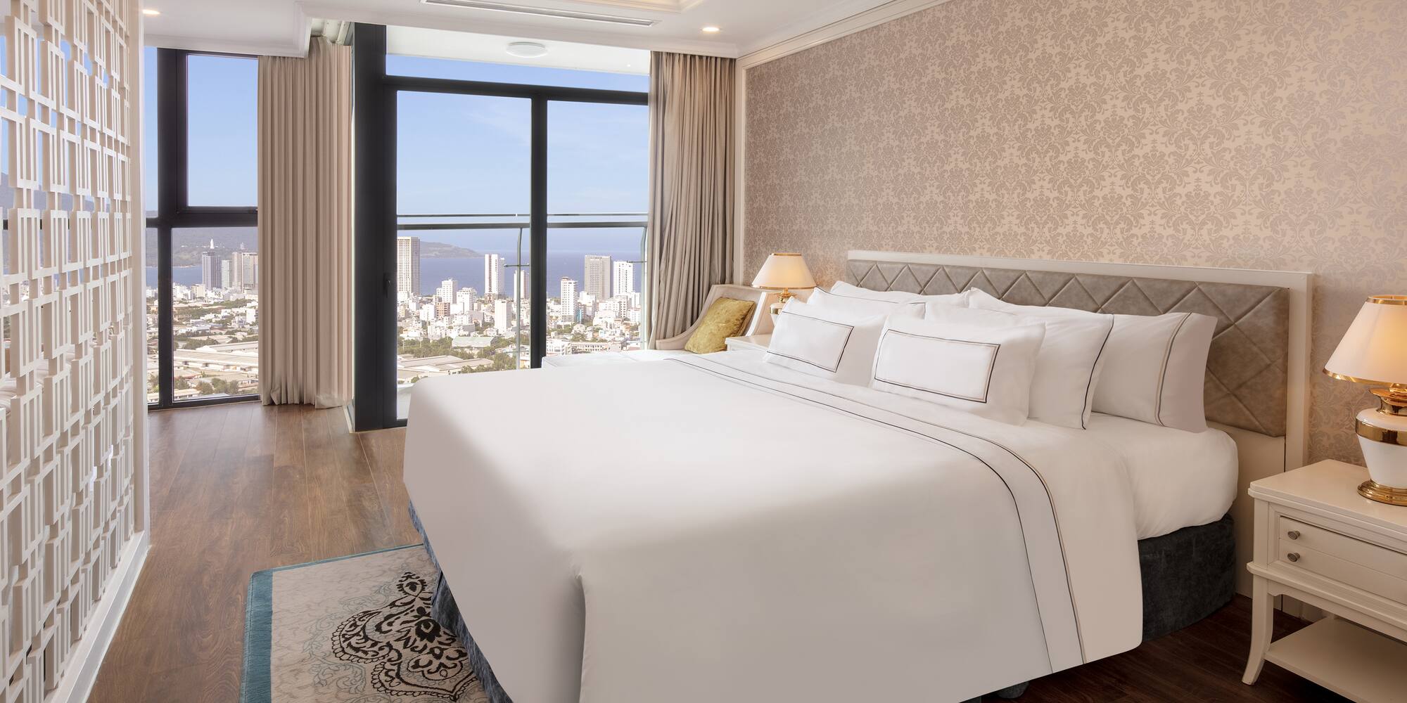 a bedroom with a large window overlooking a city