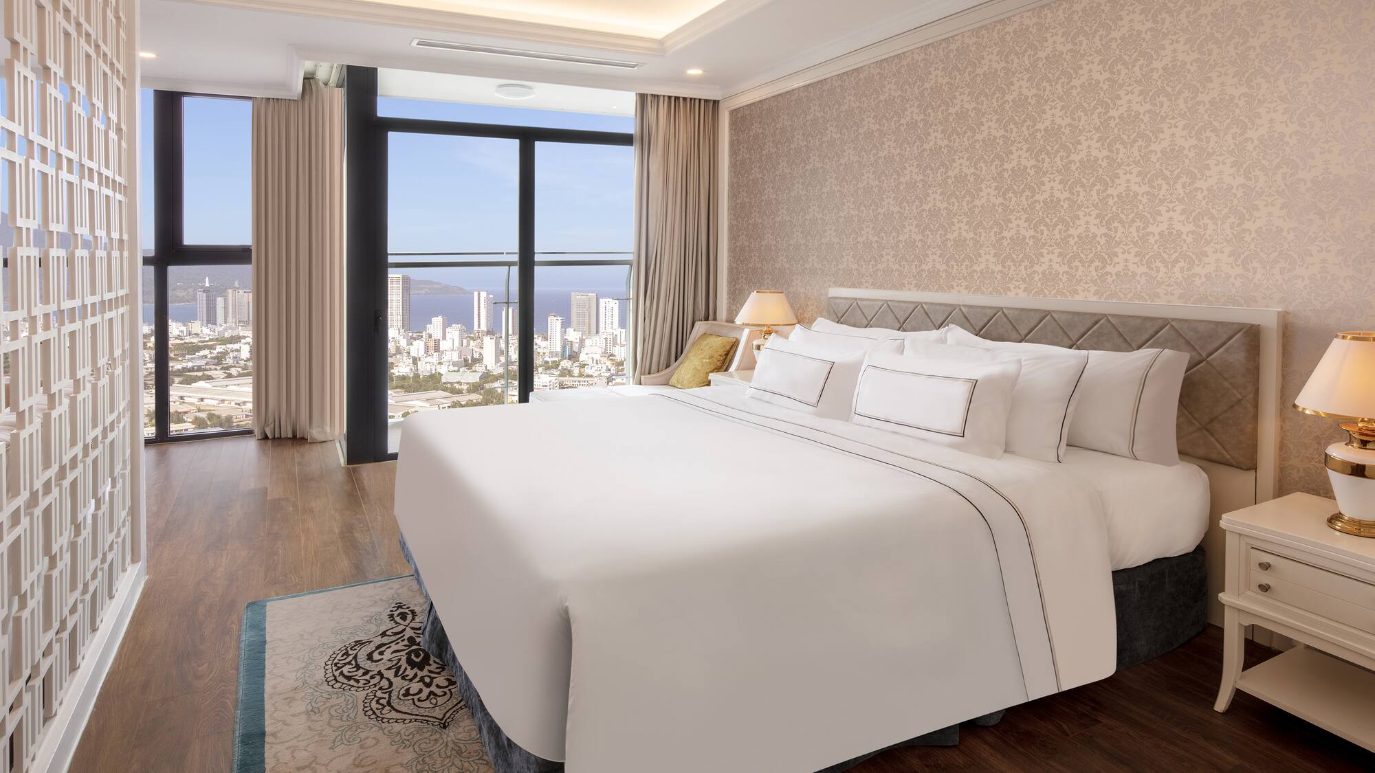 a bedroom with a large window overlooking a city