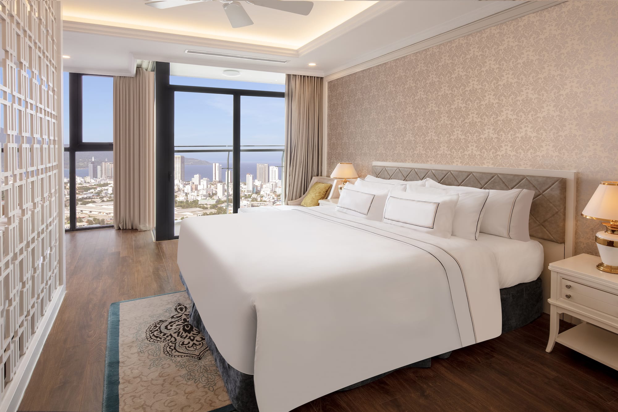 a bedroom with a large window overlooking a city