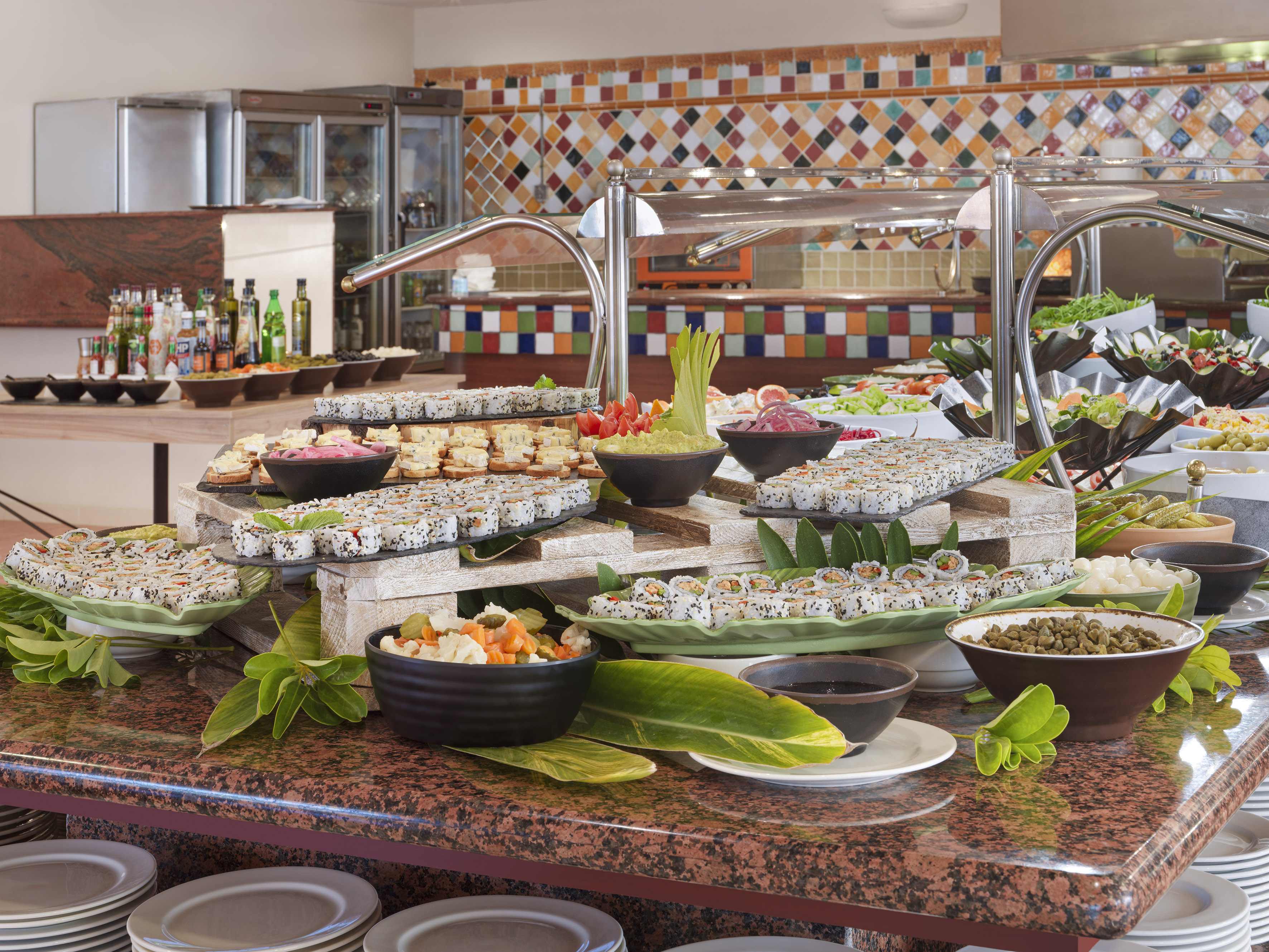 Abundant sushi, appetizer, and salad buffet in a vibrant restaurant setting.