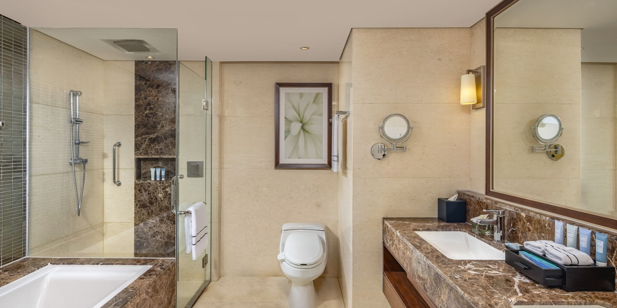 a bathroom with marble countertops and a sink