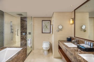 a bathroom with marble countertops and a sink