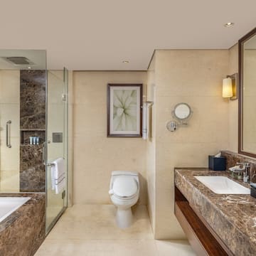 a bathroom with marble countertops and a sink