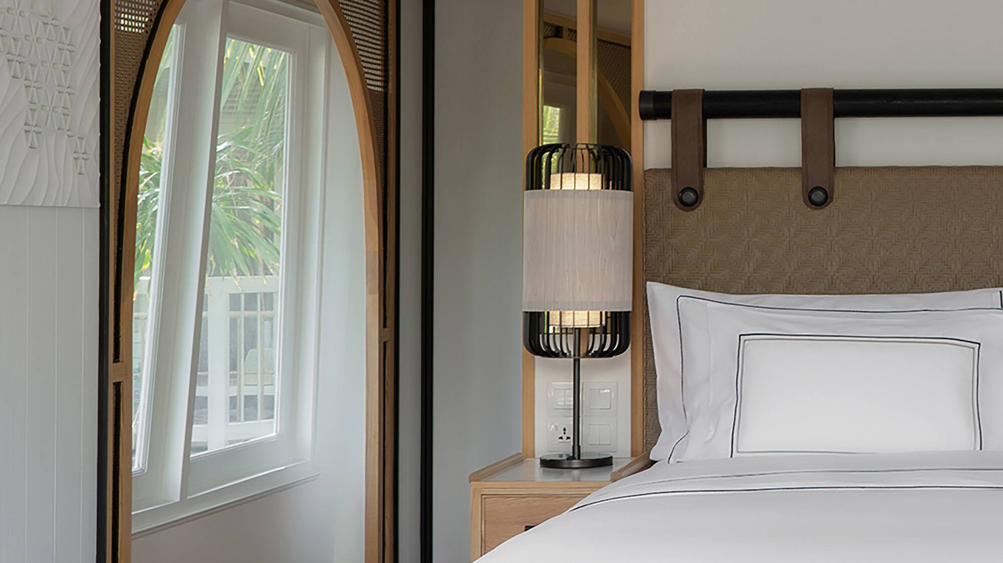 a bed with a lamp in a room