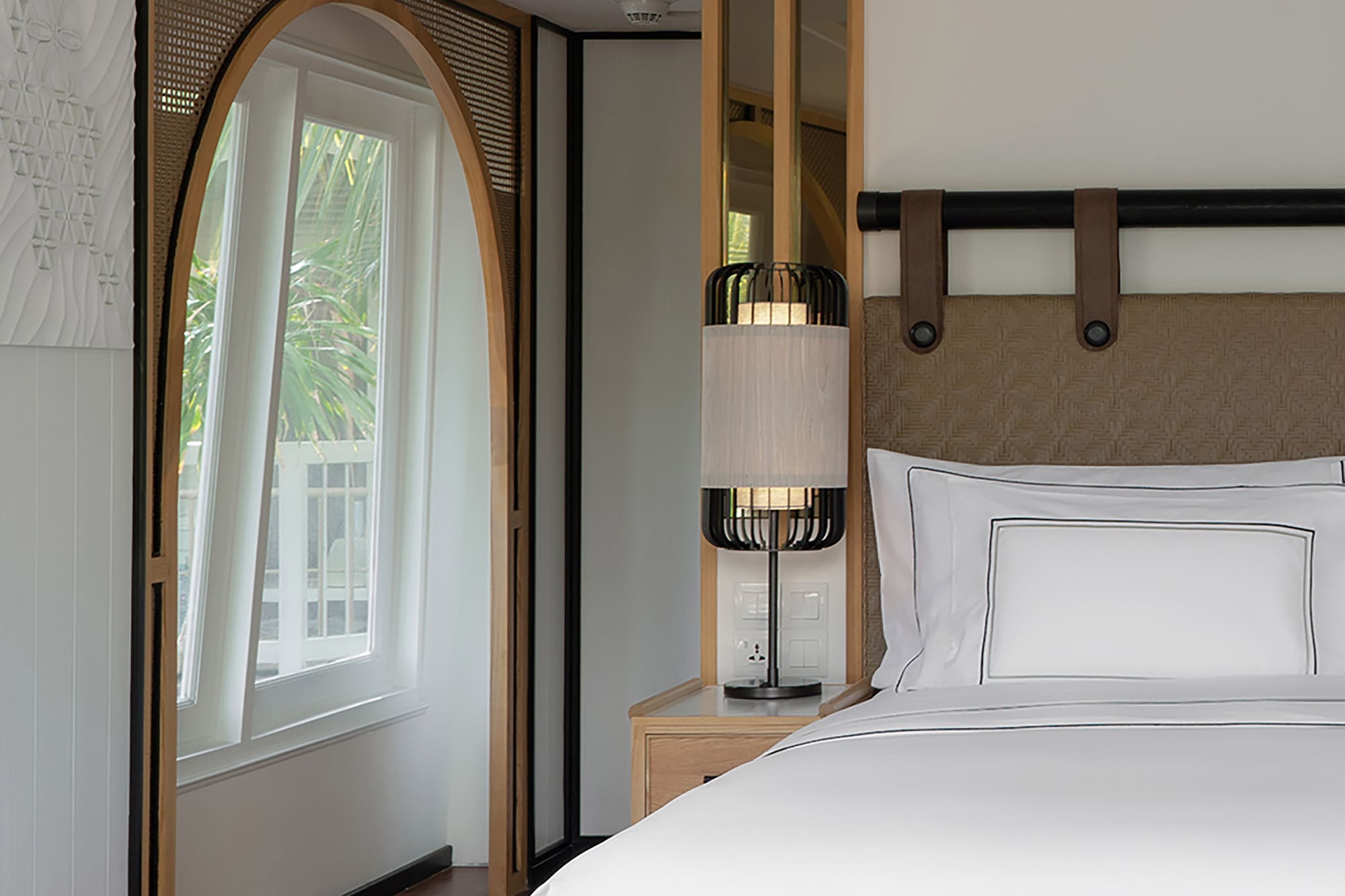 a bed with a lamp in a room