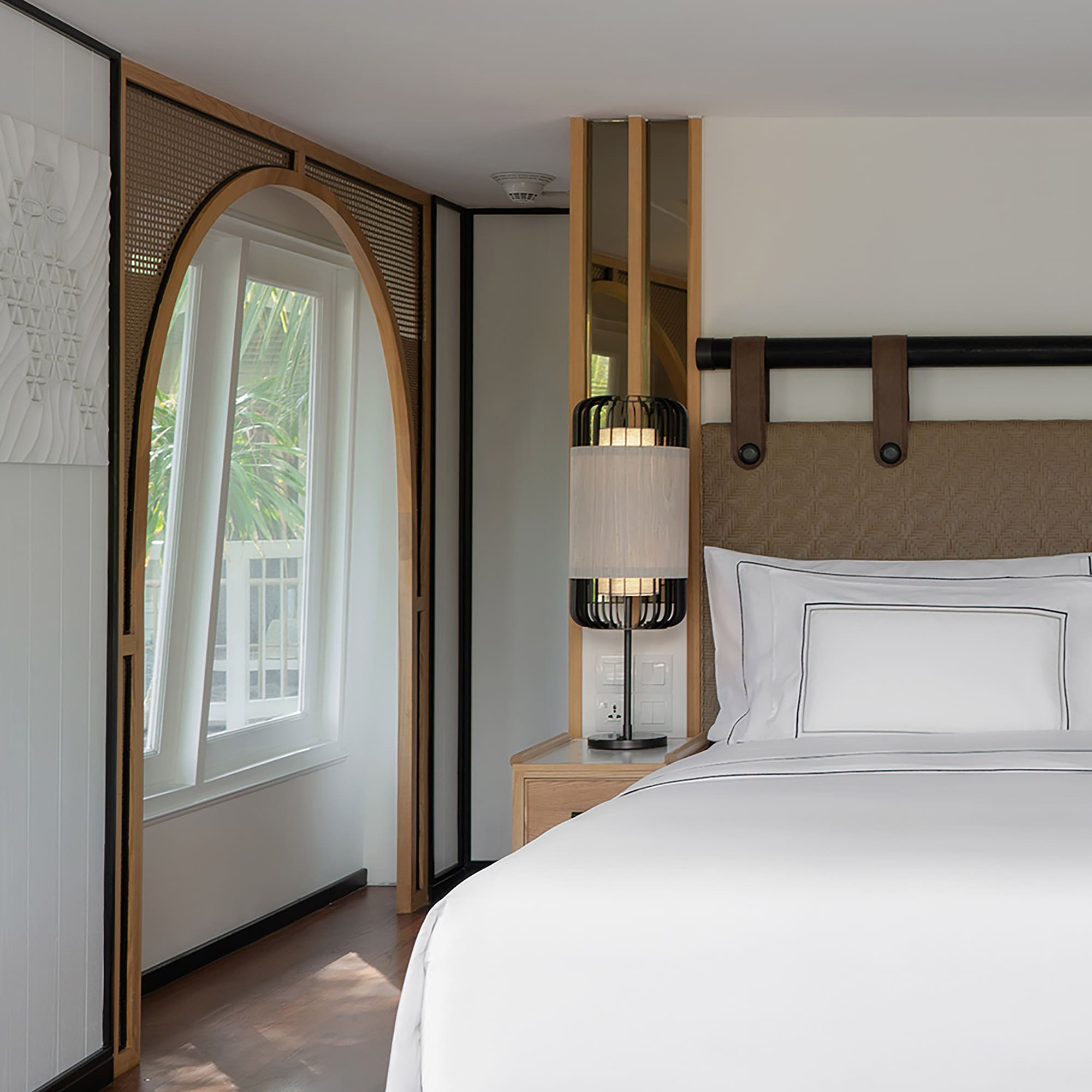 a bed with a lamp in a room