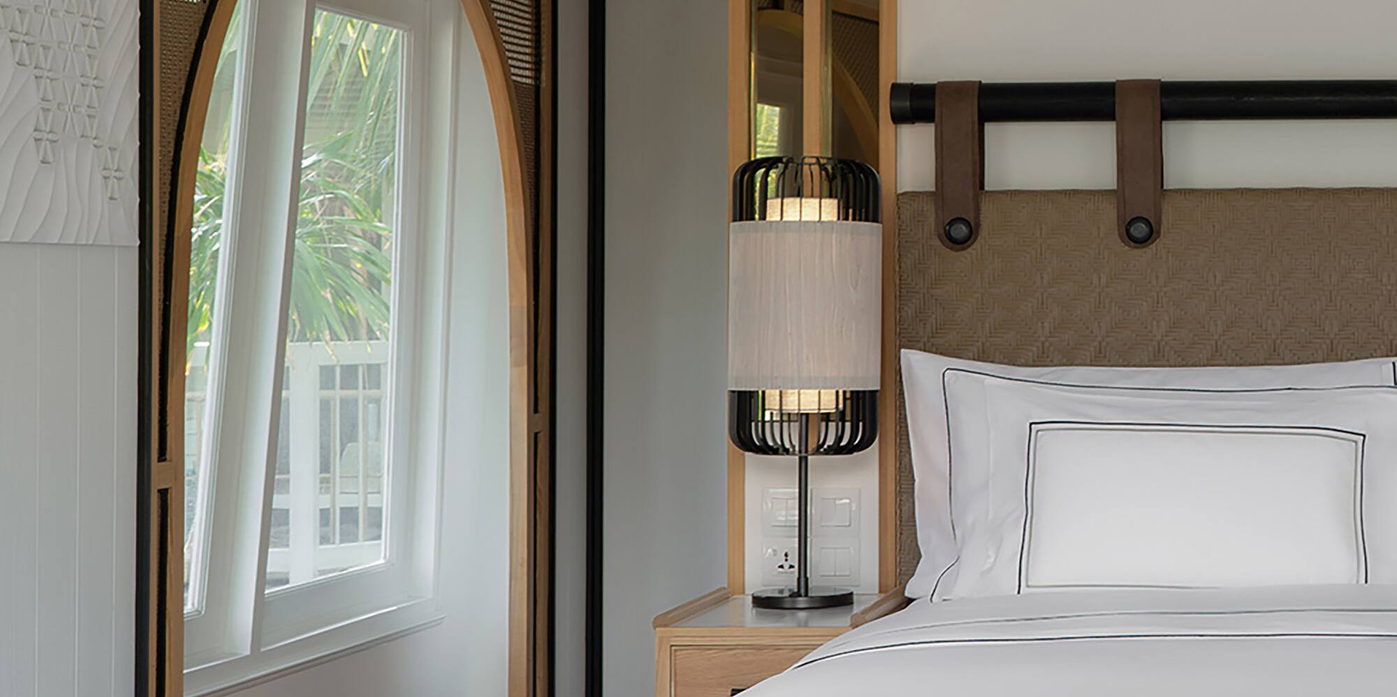 a bed with a lamp in a room