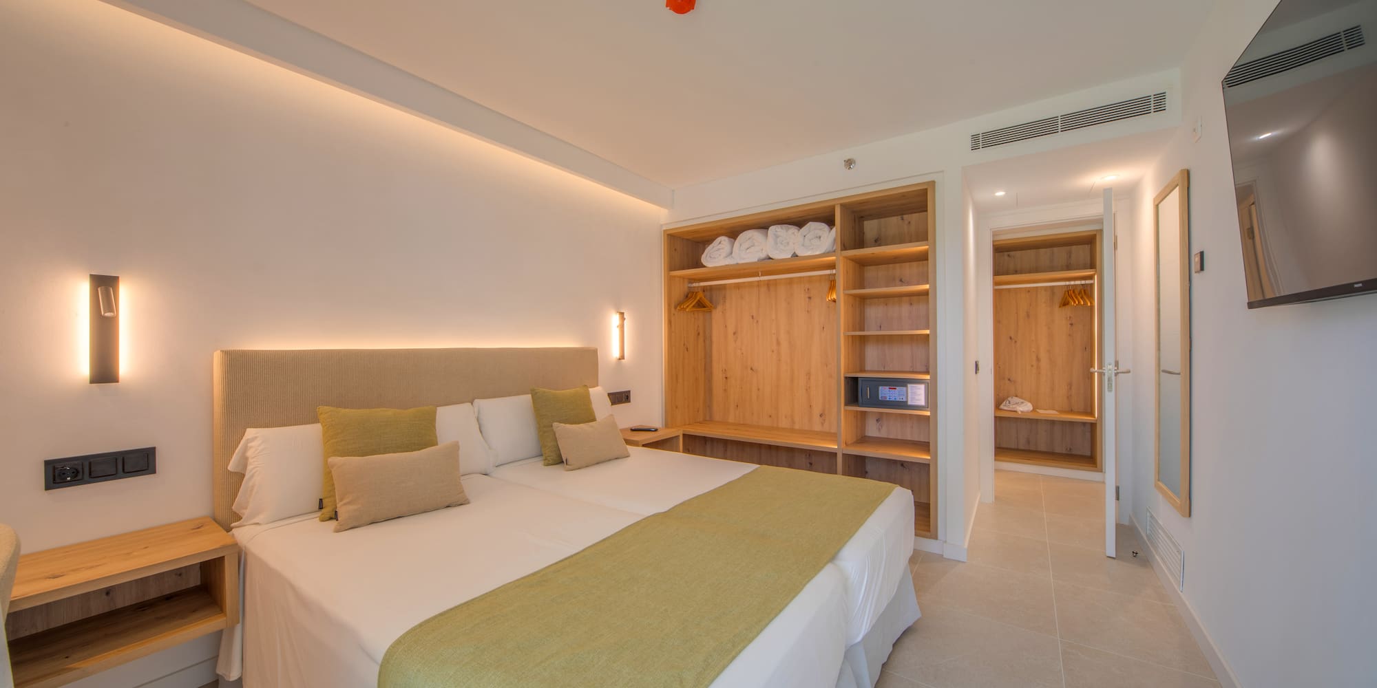 a room with a bed and shelves