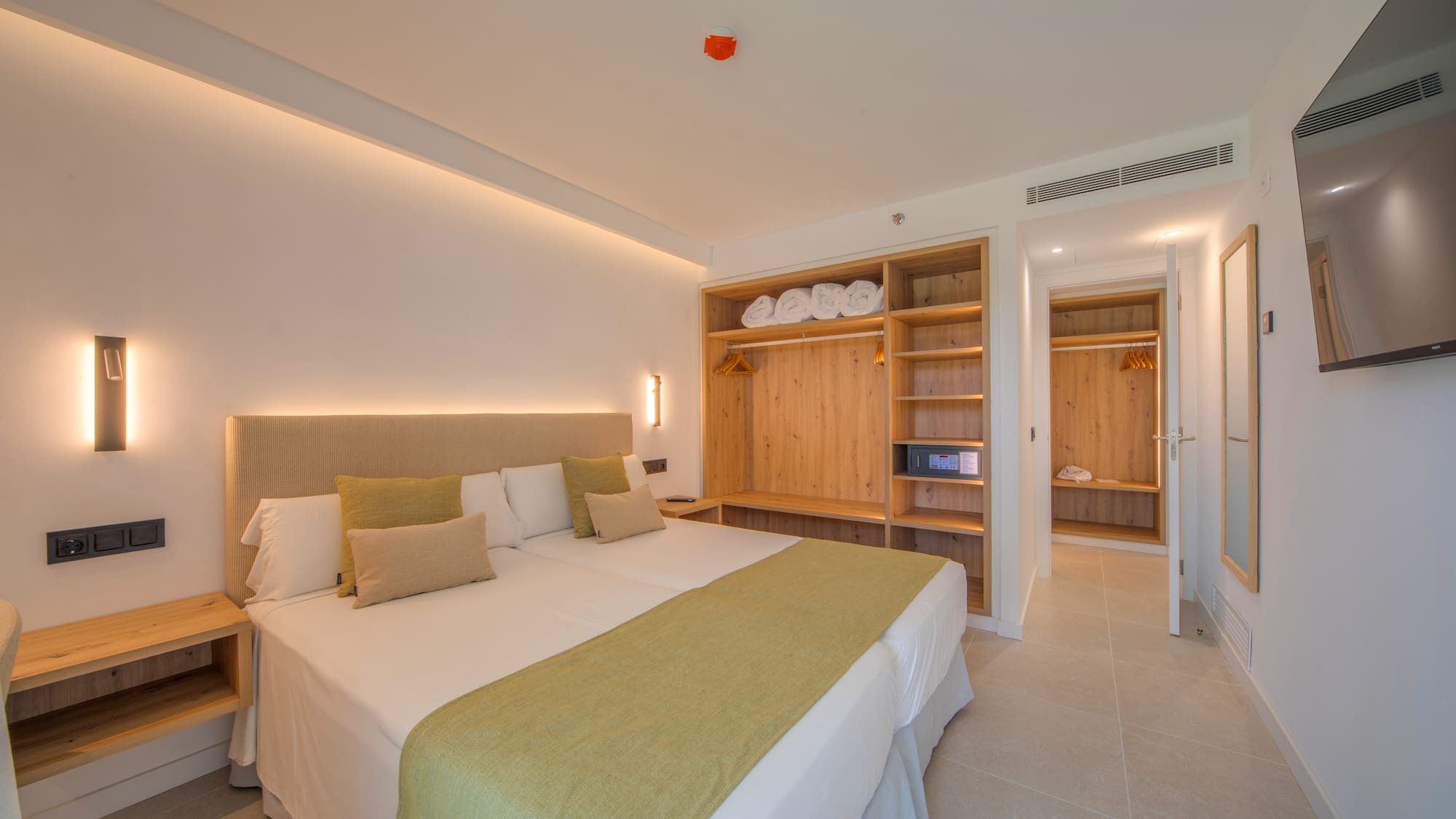 a room with a bed and shelves