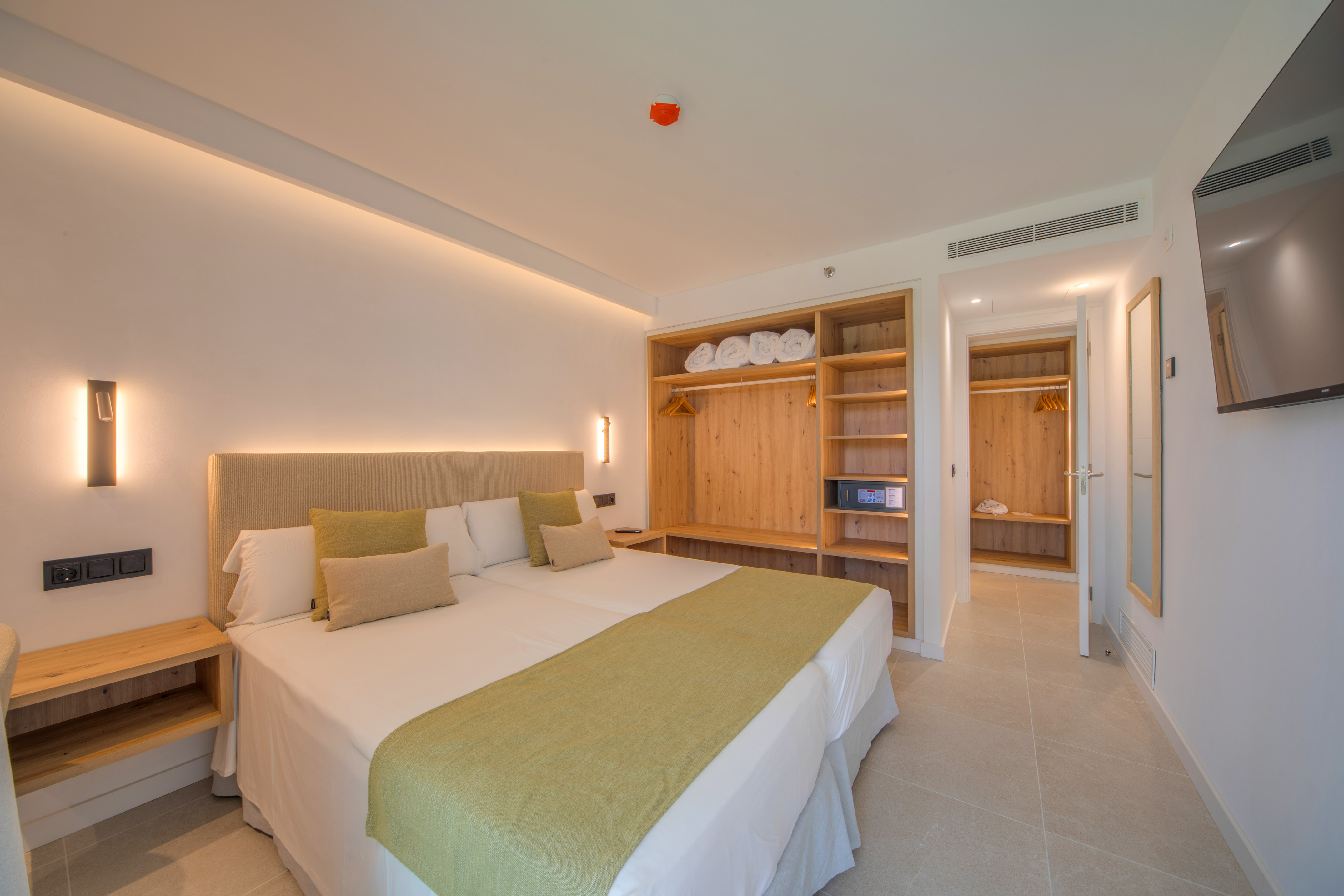 a room with a bed and shelves