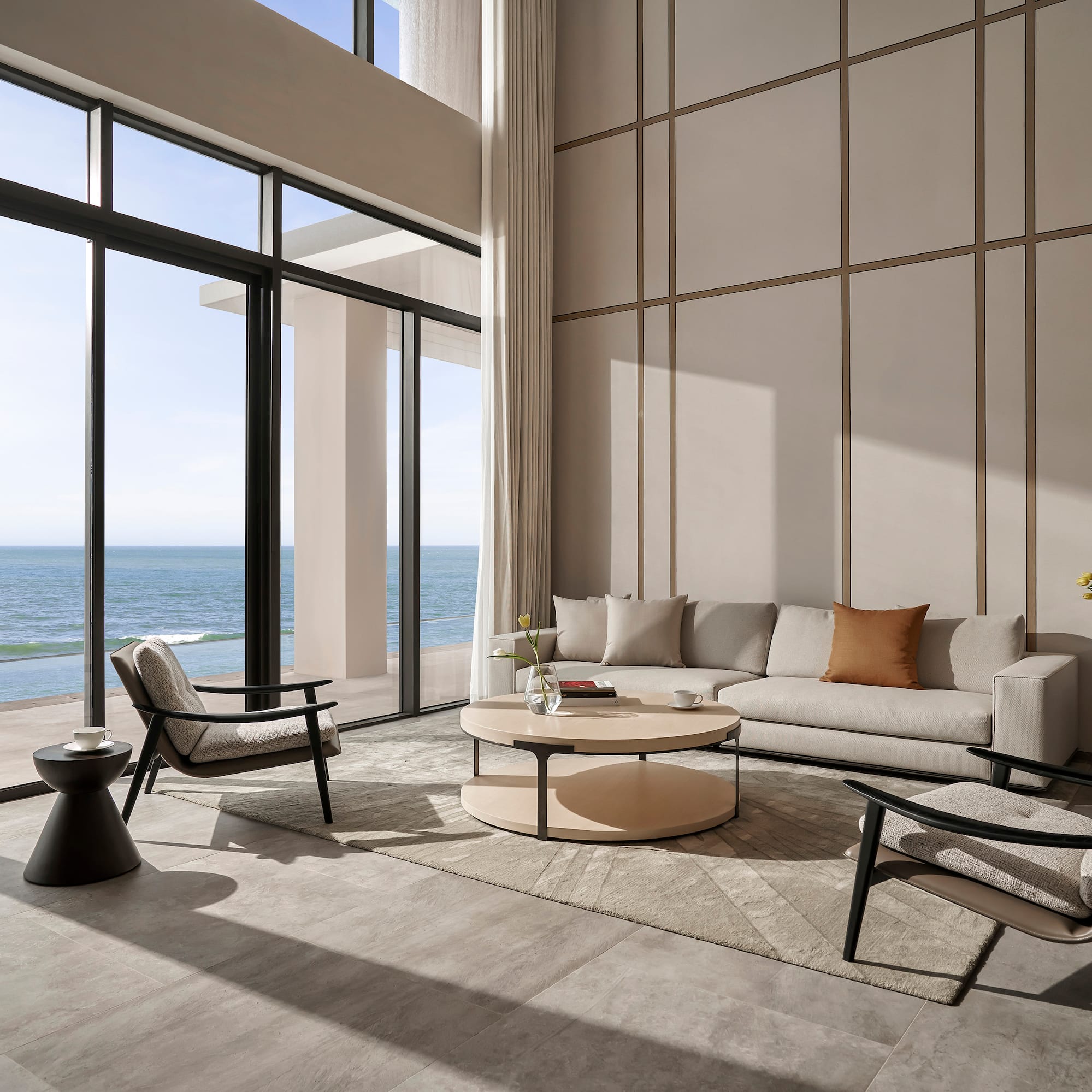 a living room with a large window overlooking the ocean