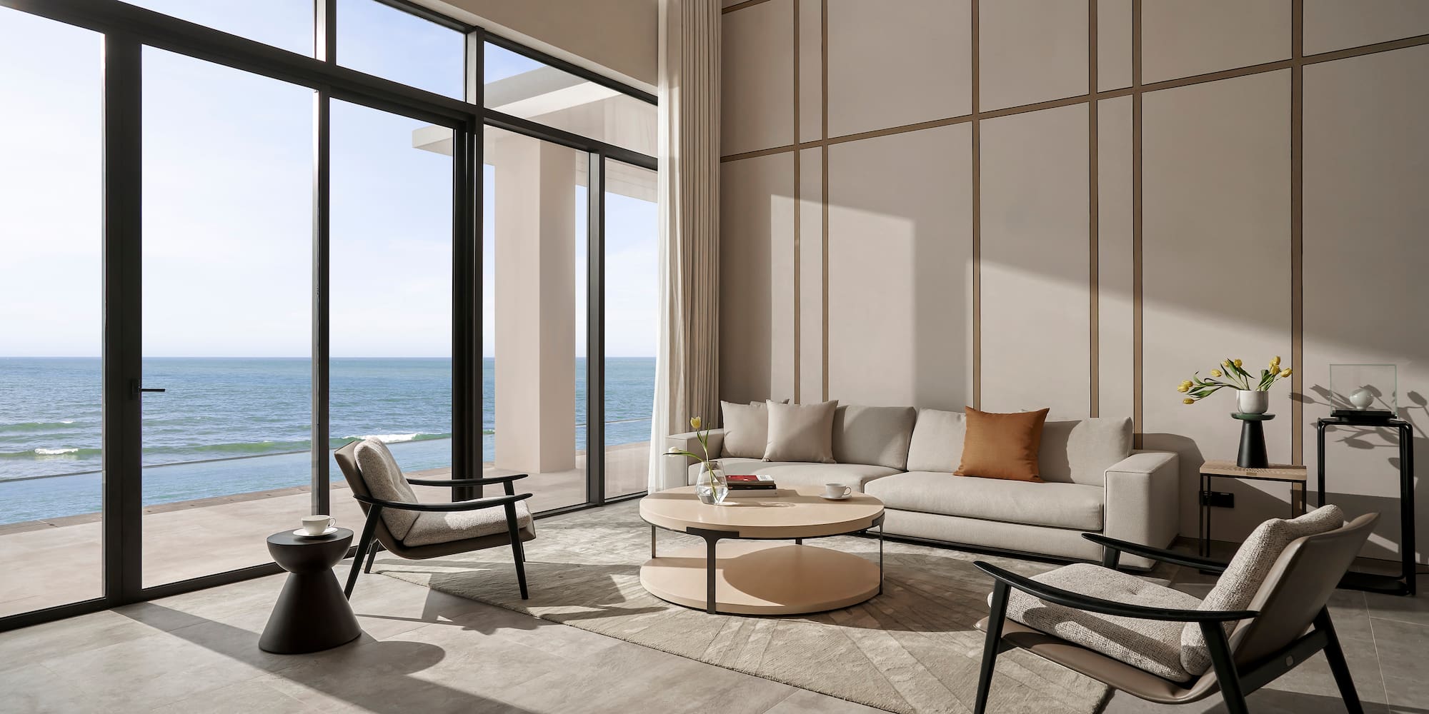 a living room with a large window overlooking the ocean