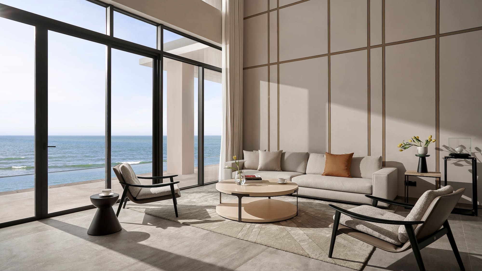 a living room with a large window overlooking the ocean