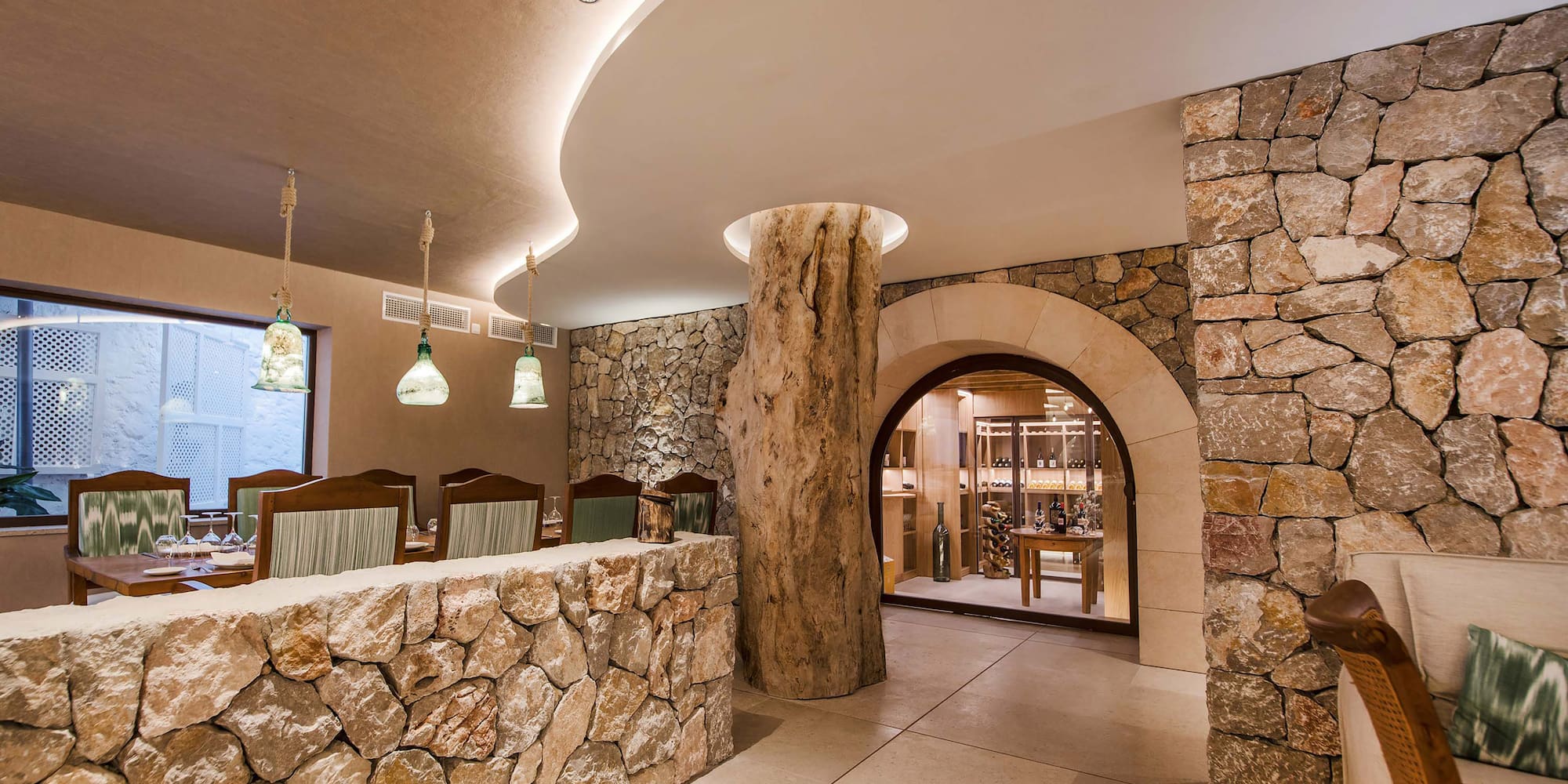 a stone wall with a tree stump in the middle