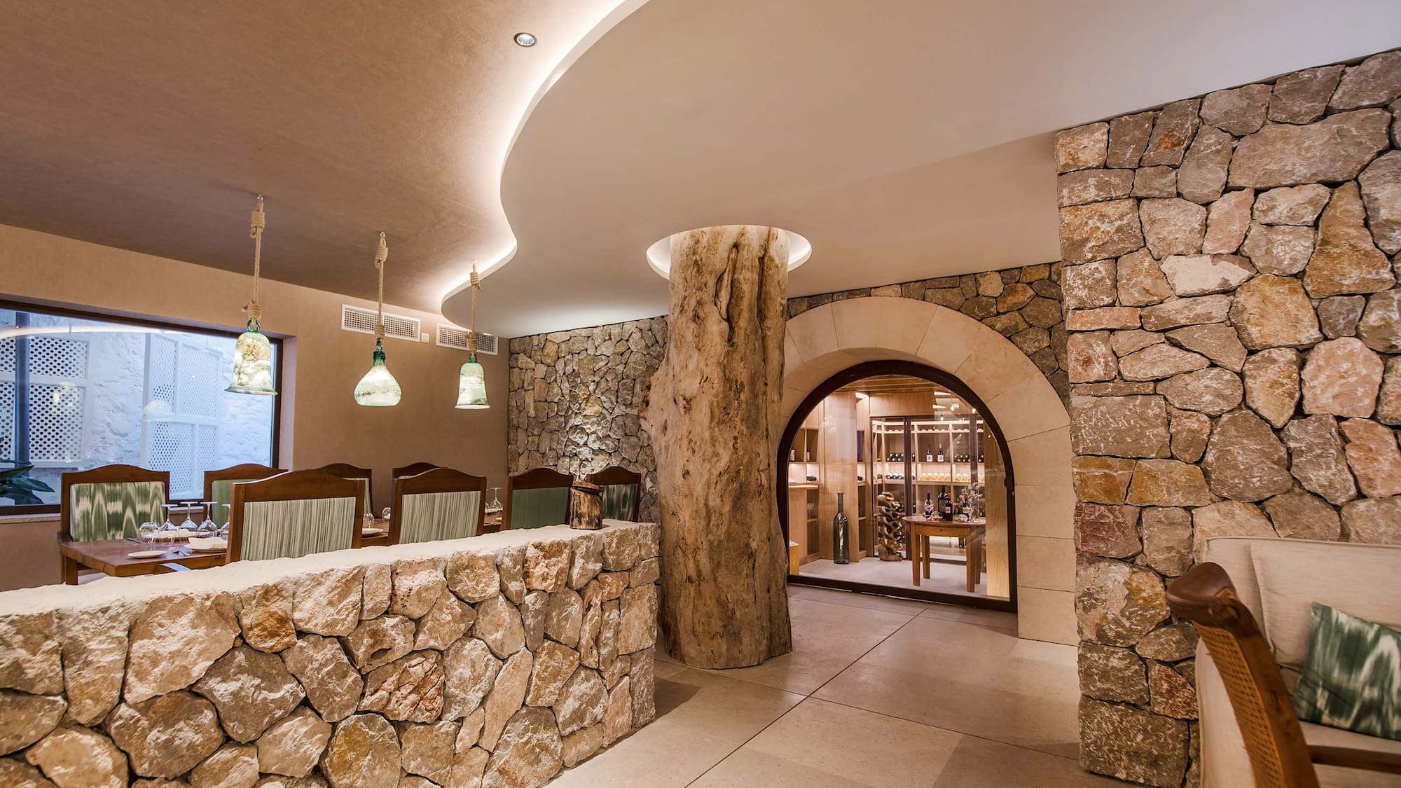 a stone wall with a tree stump in the middle