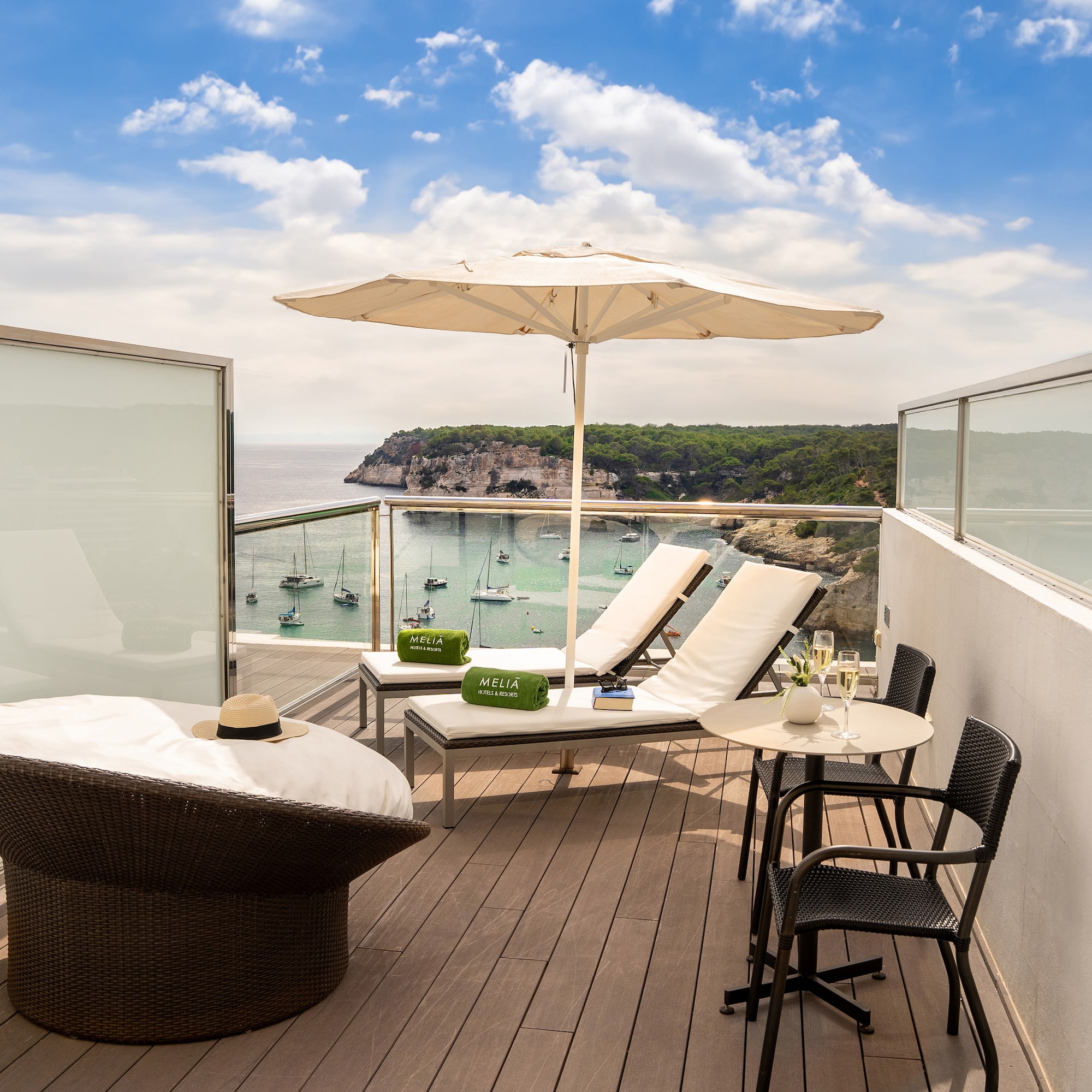 a deck with chairs and umbrellas overlooking a body of water