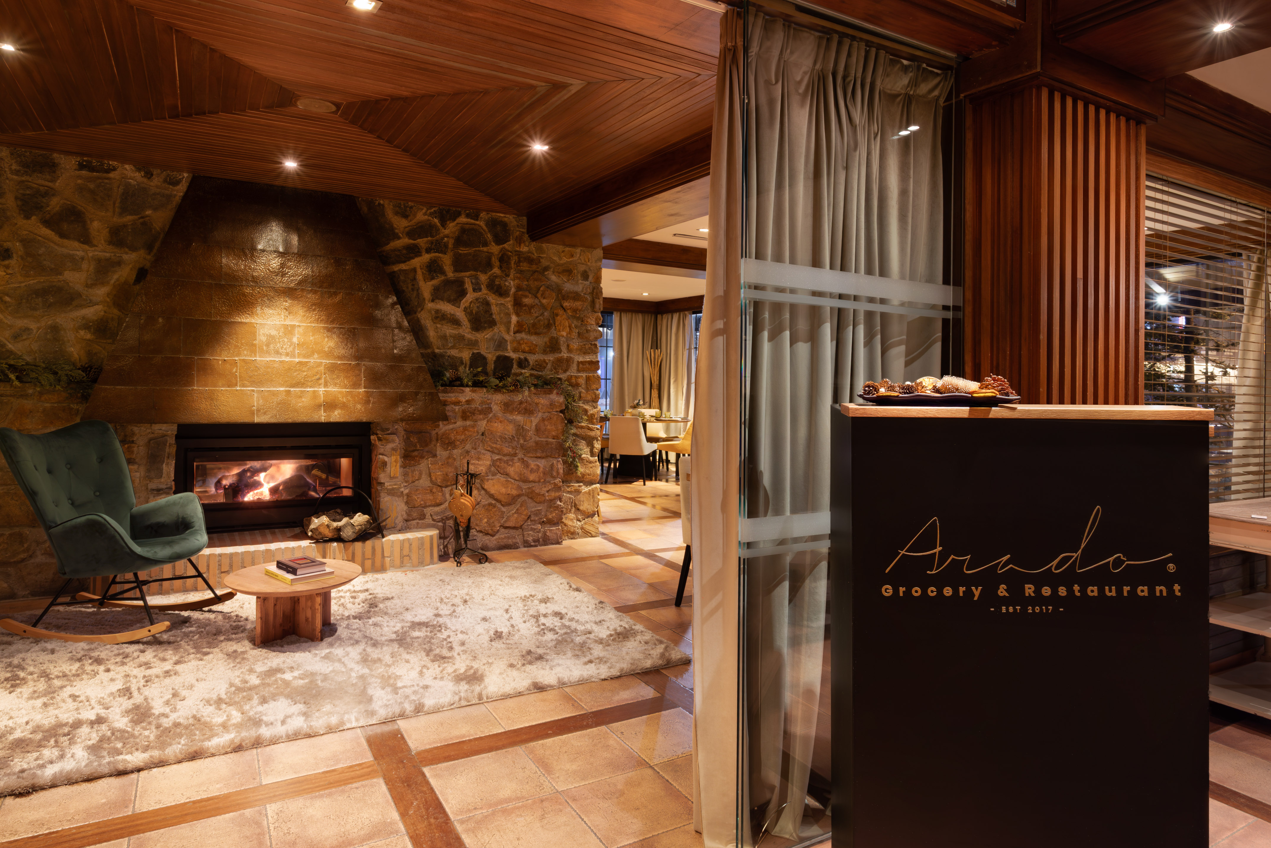 Arado Grocery & Restaurant: fireplace, green chair, reception area.