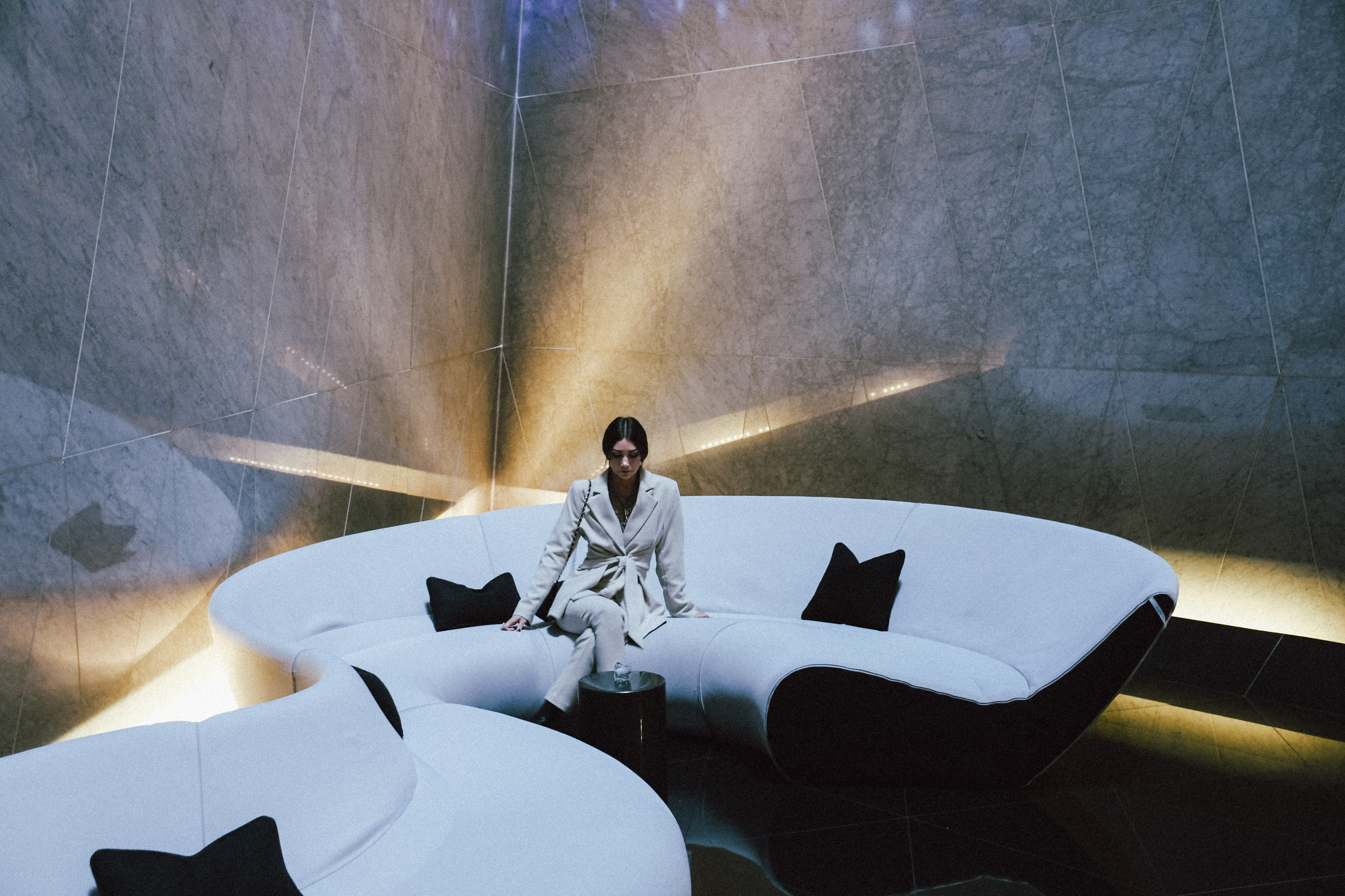 a woman sitting on a white couch