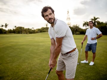 a man holding a golf club