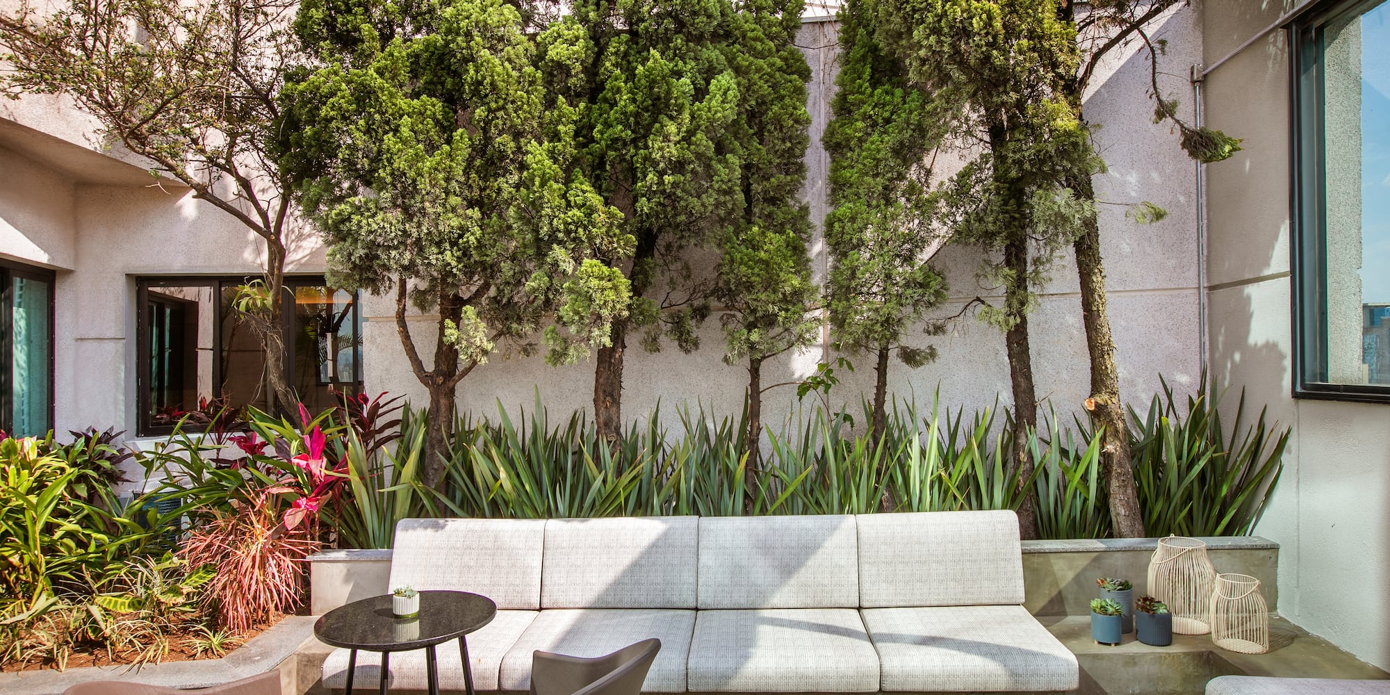 a white couch and table in a courtyard