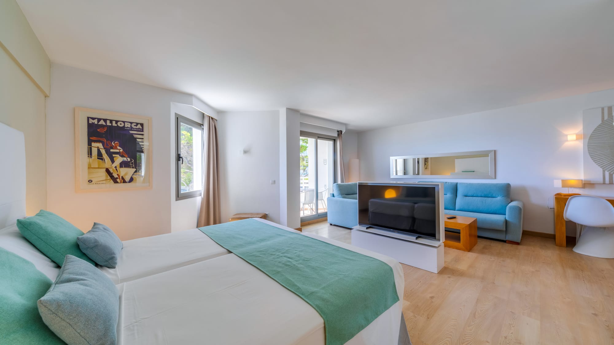 a room with two beds and a television