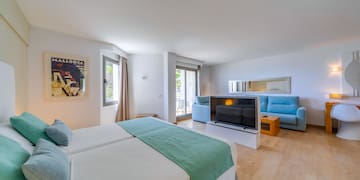 a room with two beds and a television