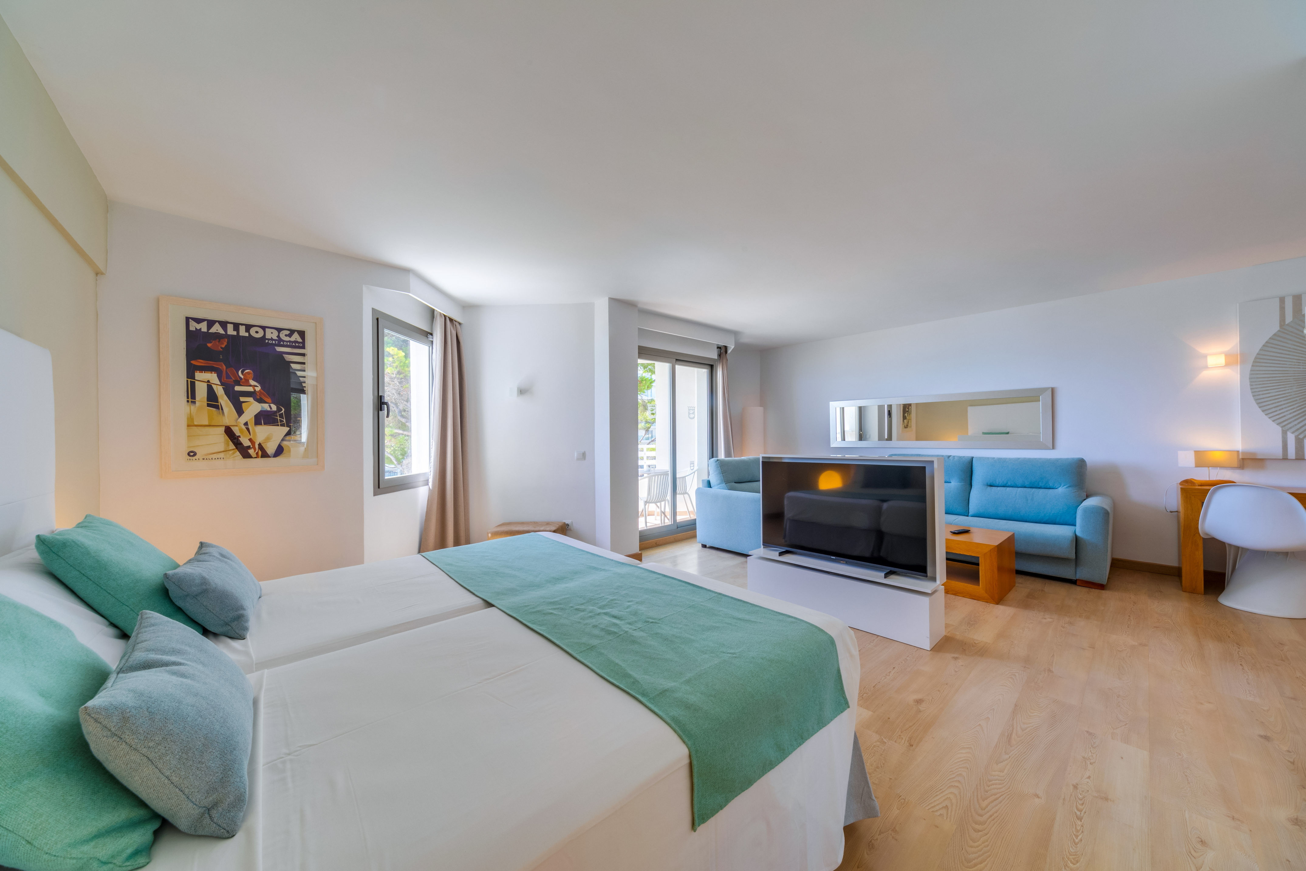 a room with two beds and a television