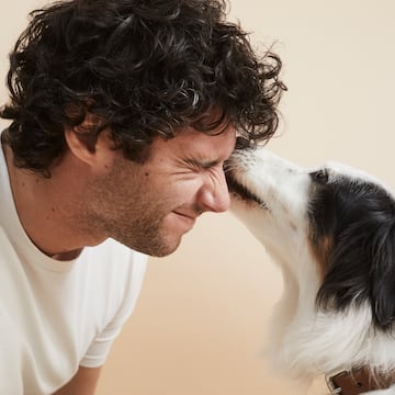 a man with his nose on a dog