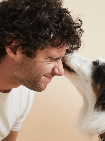 a man with his nose on a dog