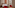 Contemporary hotel room, red chairs, patterned headboard art, city view.