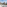 Sunny hotel balcony with sea view, overlooking coastal city and beach.