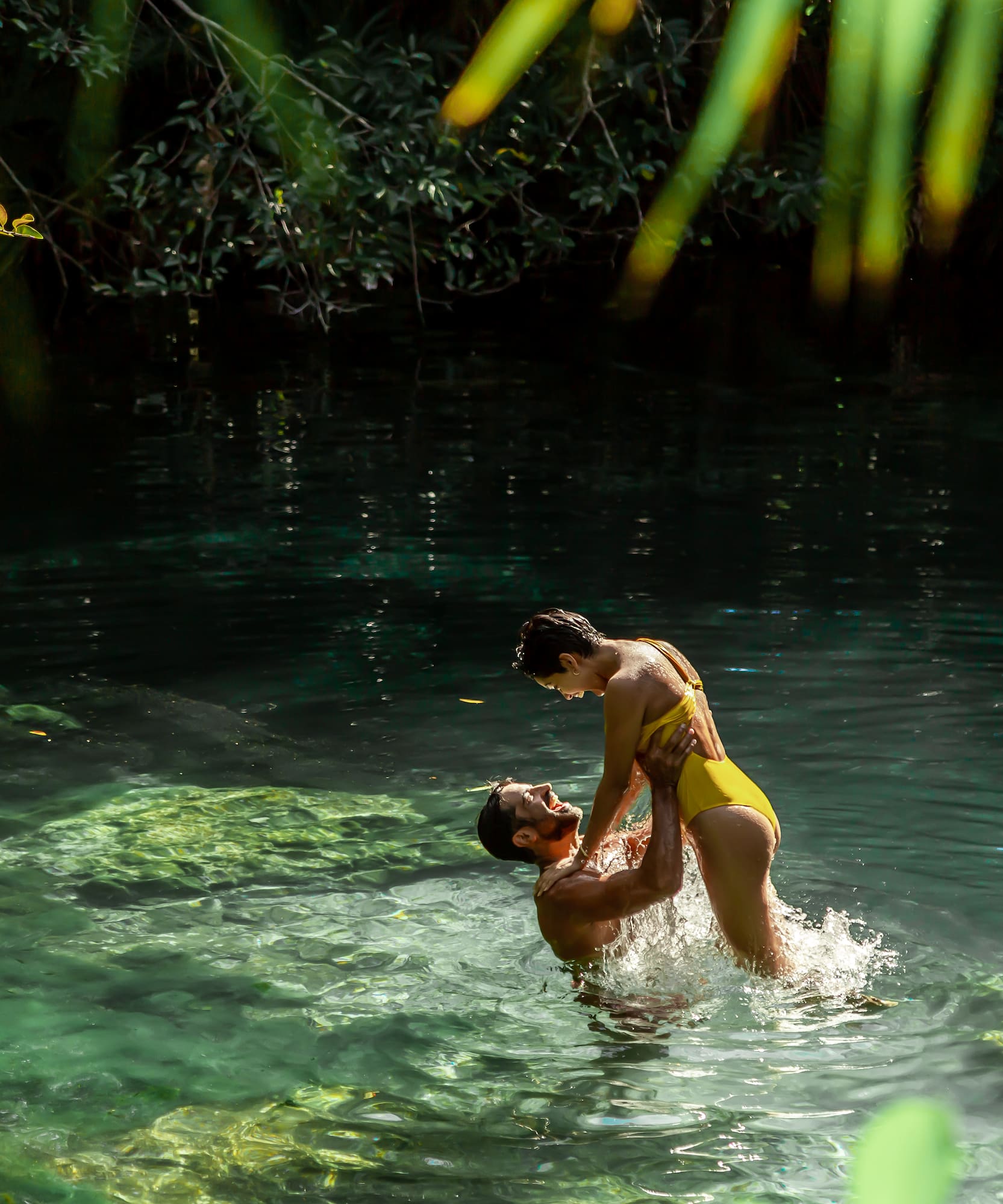 a man and woman in a body of water