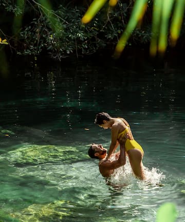 a man and woman in a body of water