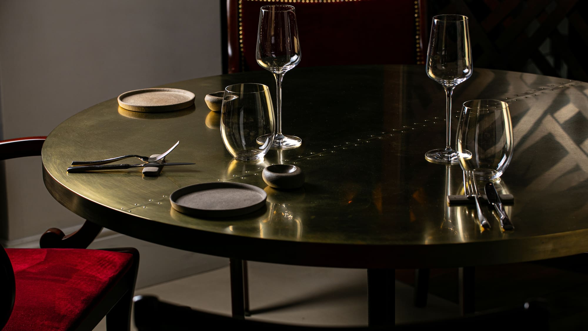 a table with wine glasses and utensils