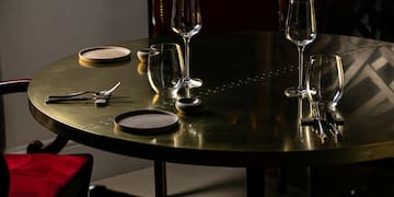 a table with wine glasses and utensils
