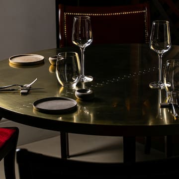 a table with wine glasses and utensils